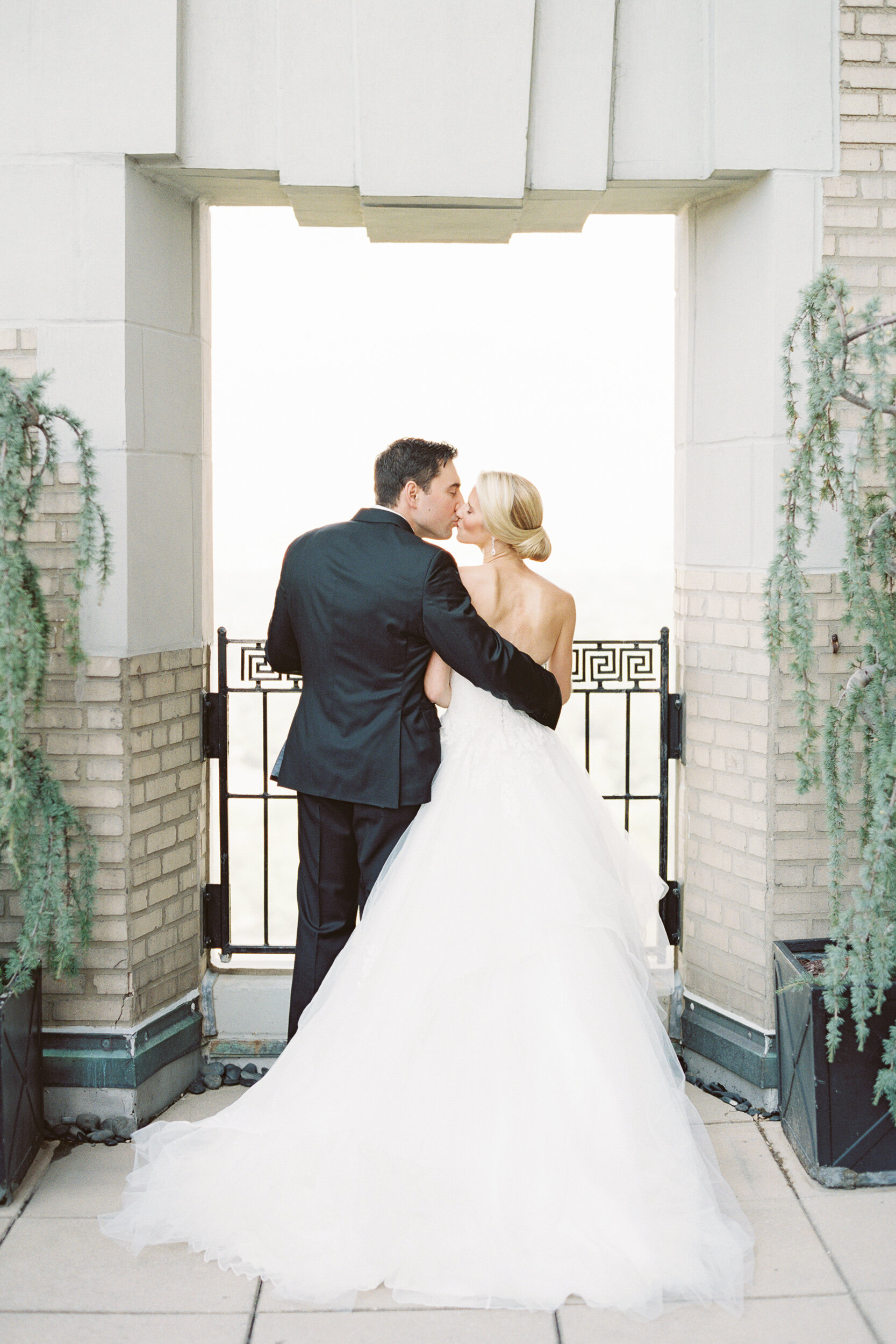 Bride and Groom Kissing Overlooking Central Park at The Essex House