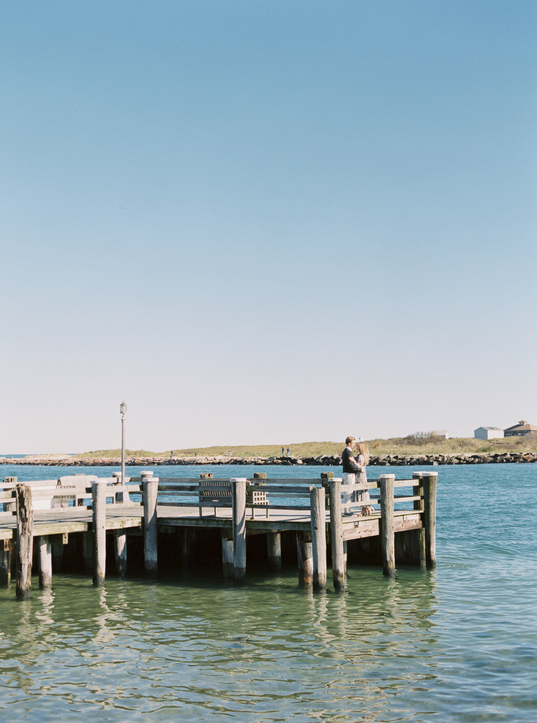 Couple on pier at their engagement session in Montauk