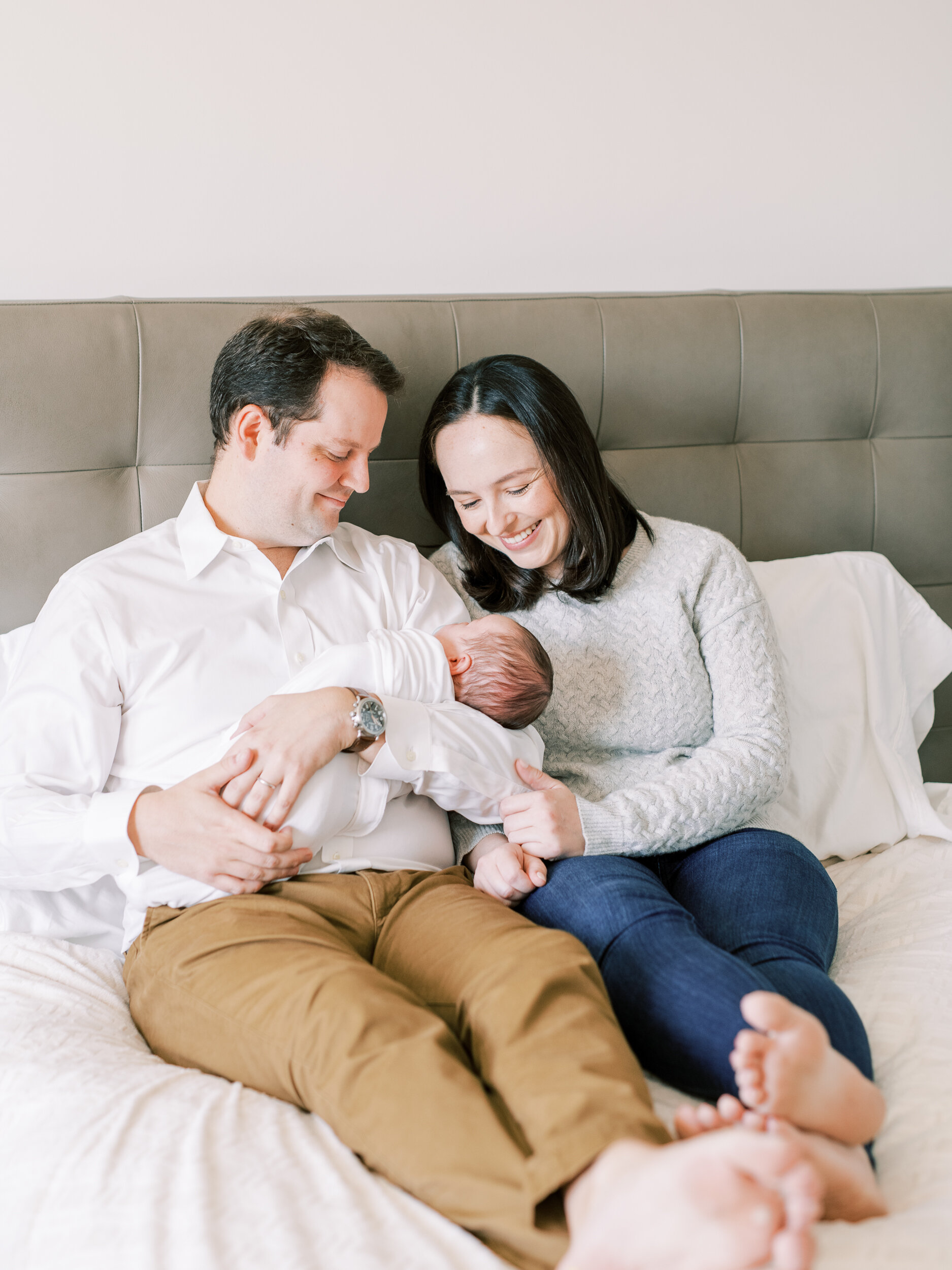 Mom and dad holding newborn at newborn session in New York City 