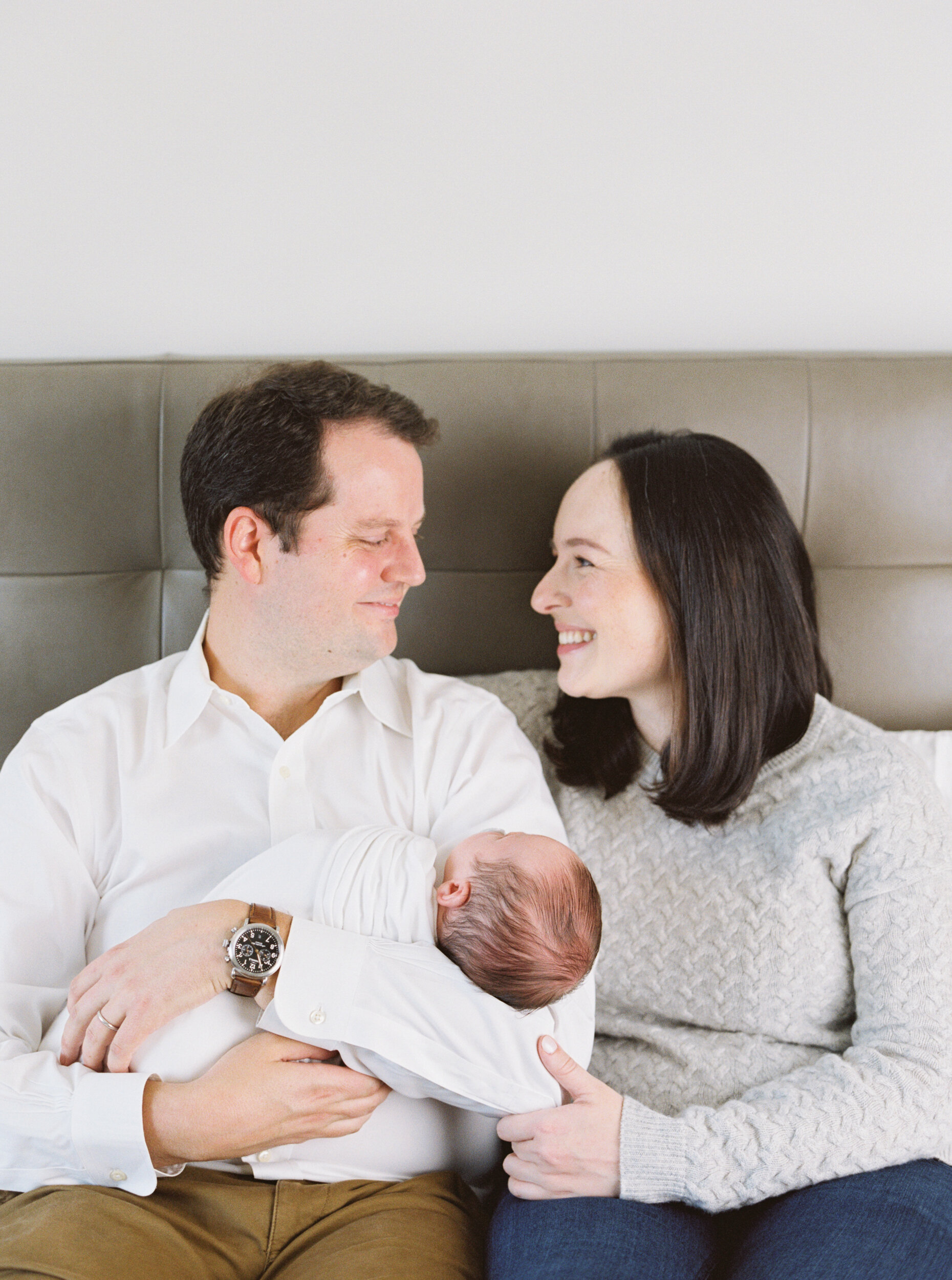 Parents holding newborn at newborn session in NYC 