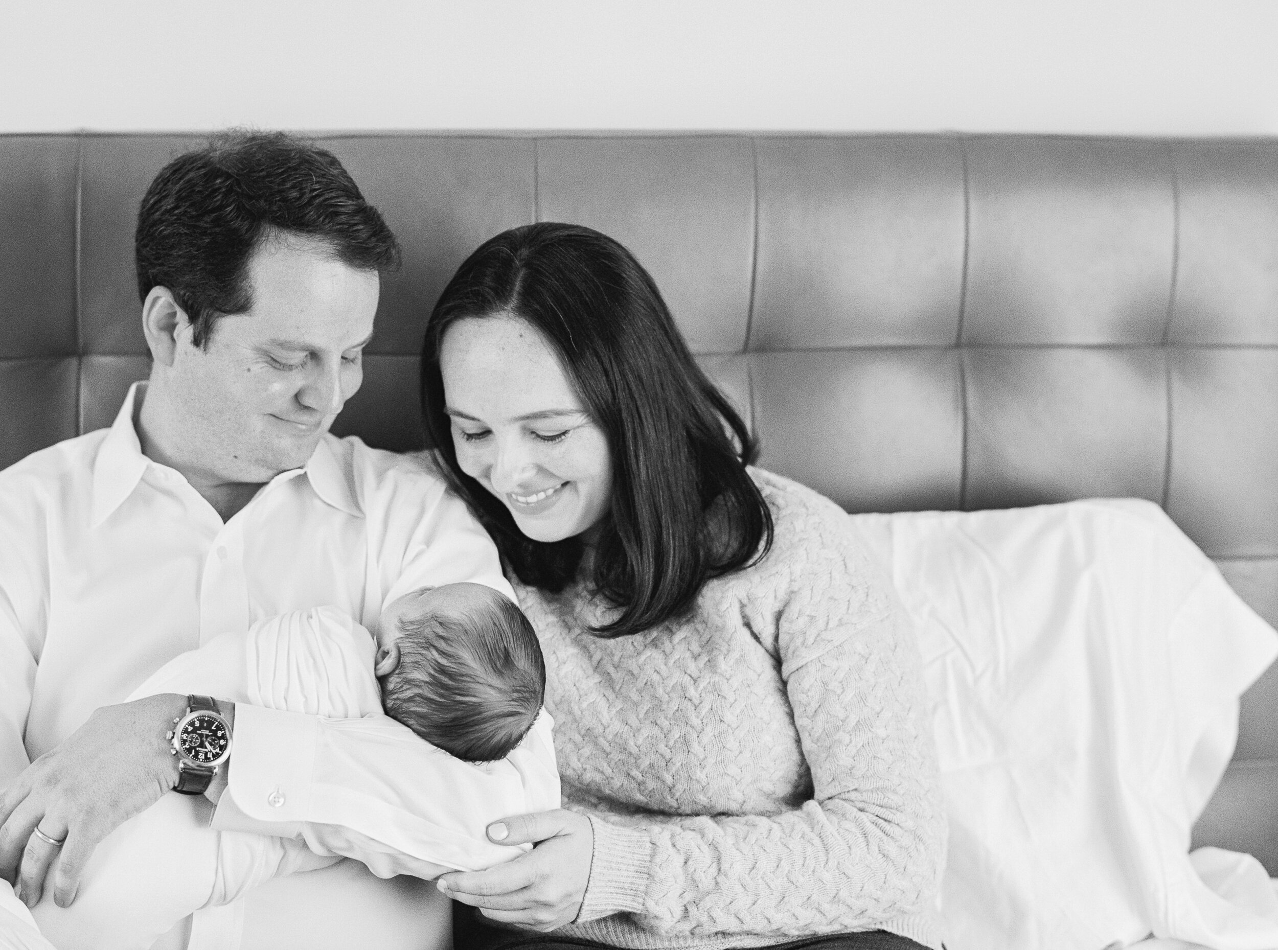 Parents holding newborn at newborn session in NYC 
