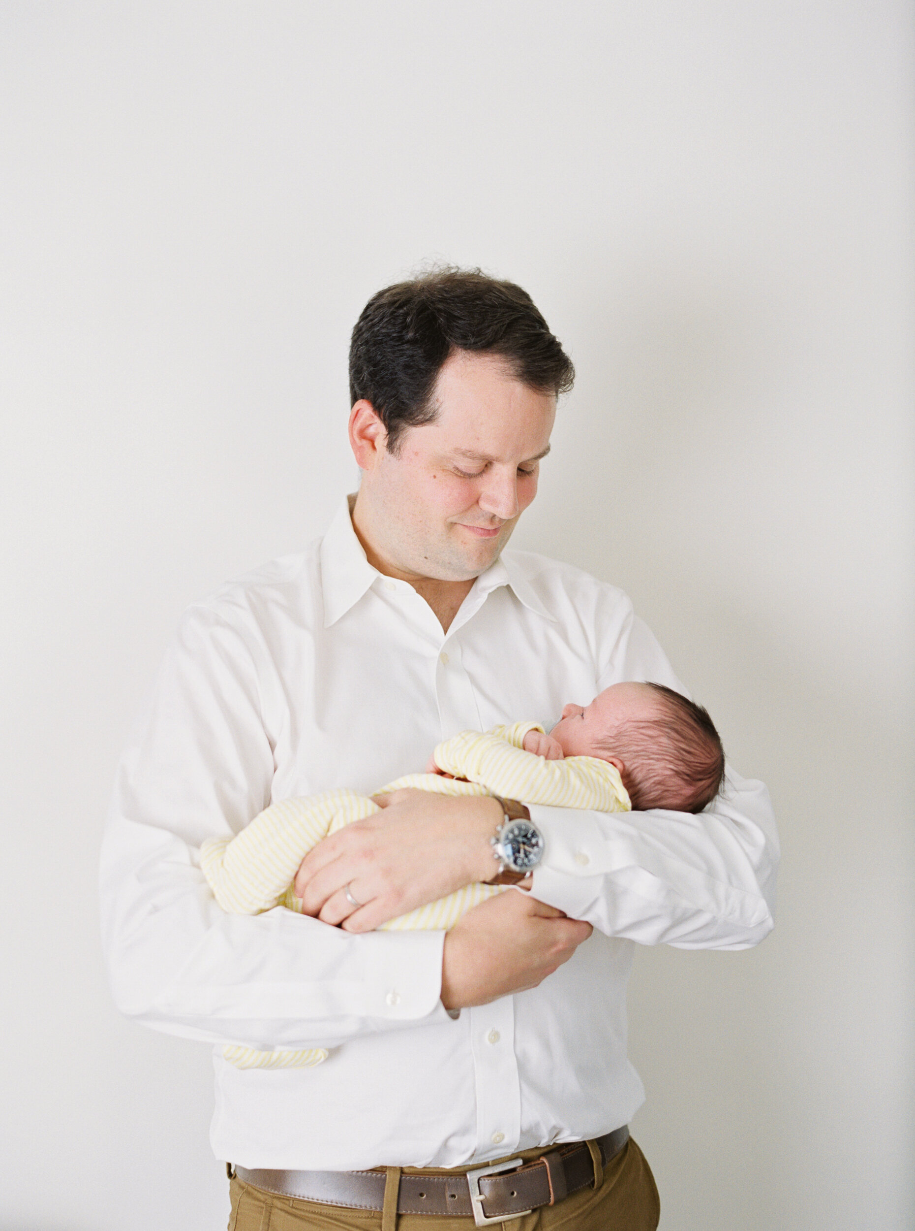 Dad holding newborn at newborn session in NYC 