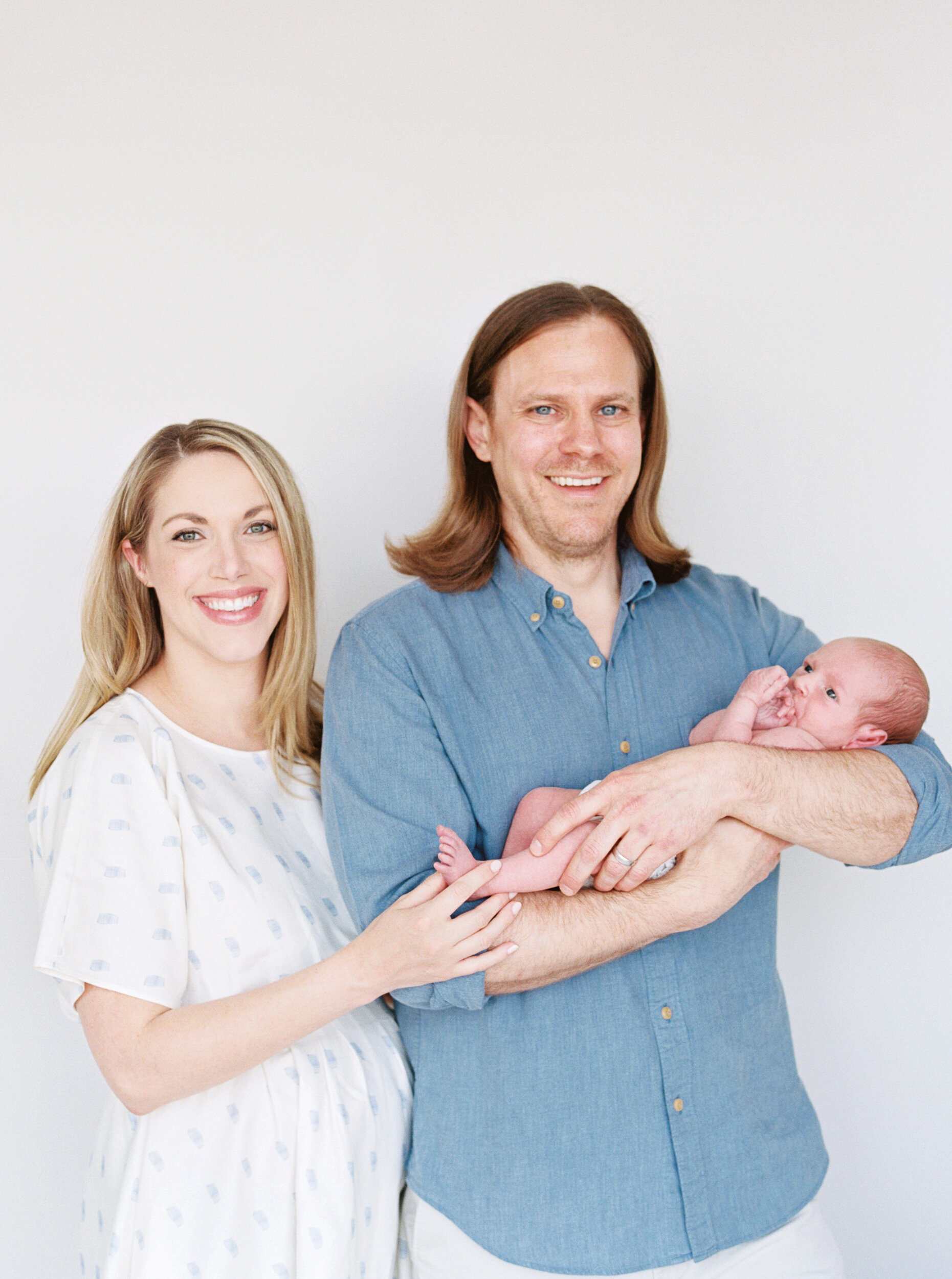 Mom and Dad holding baby boy for Newborn Photos