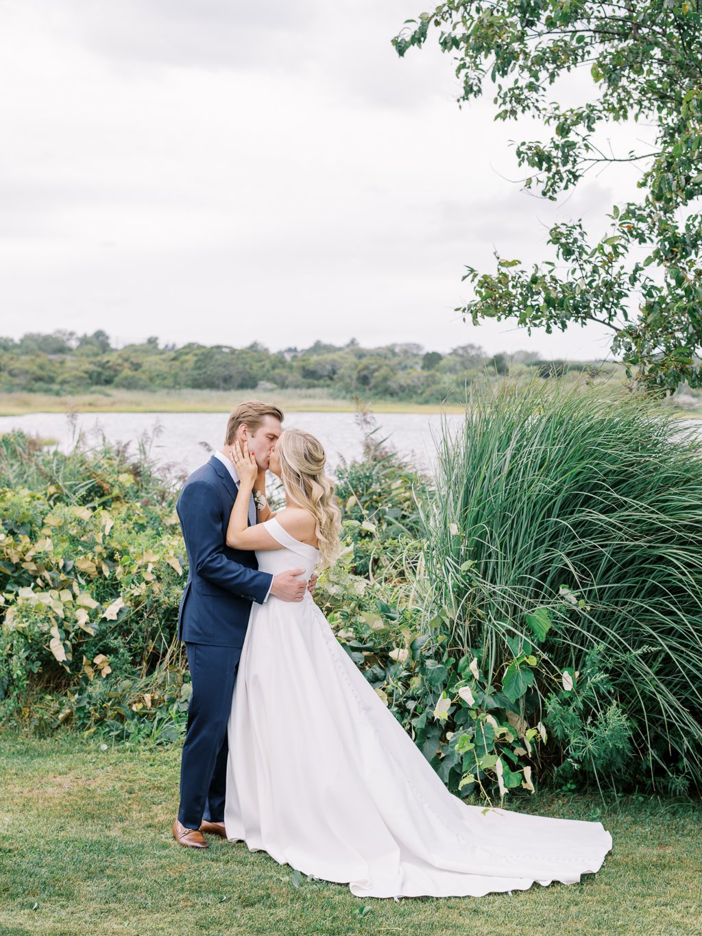 Bride and Groom sharing a Kiss with Lake Montauk in Background