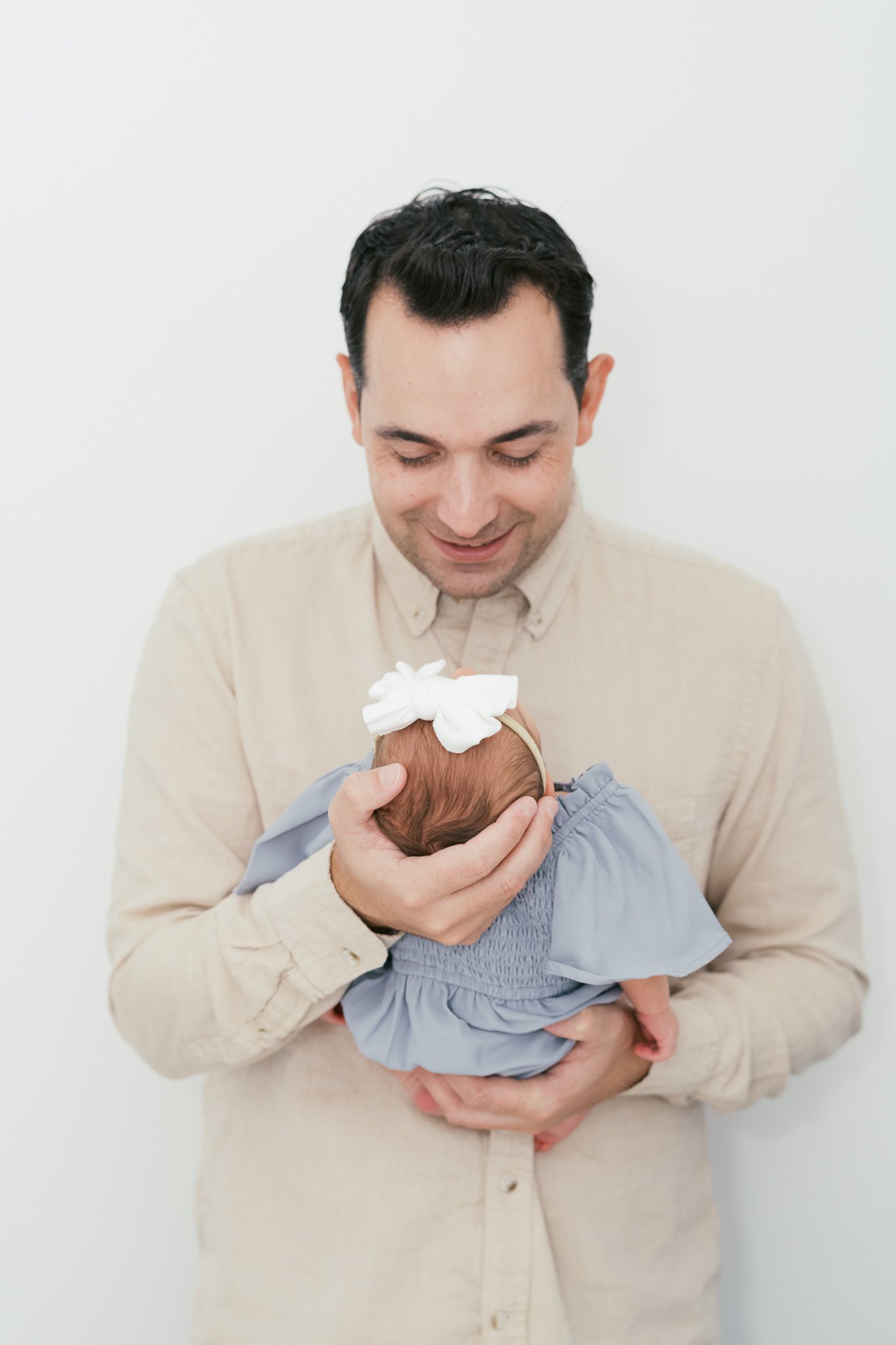 Dad holding Baby Girl during Newborn Session