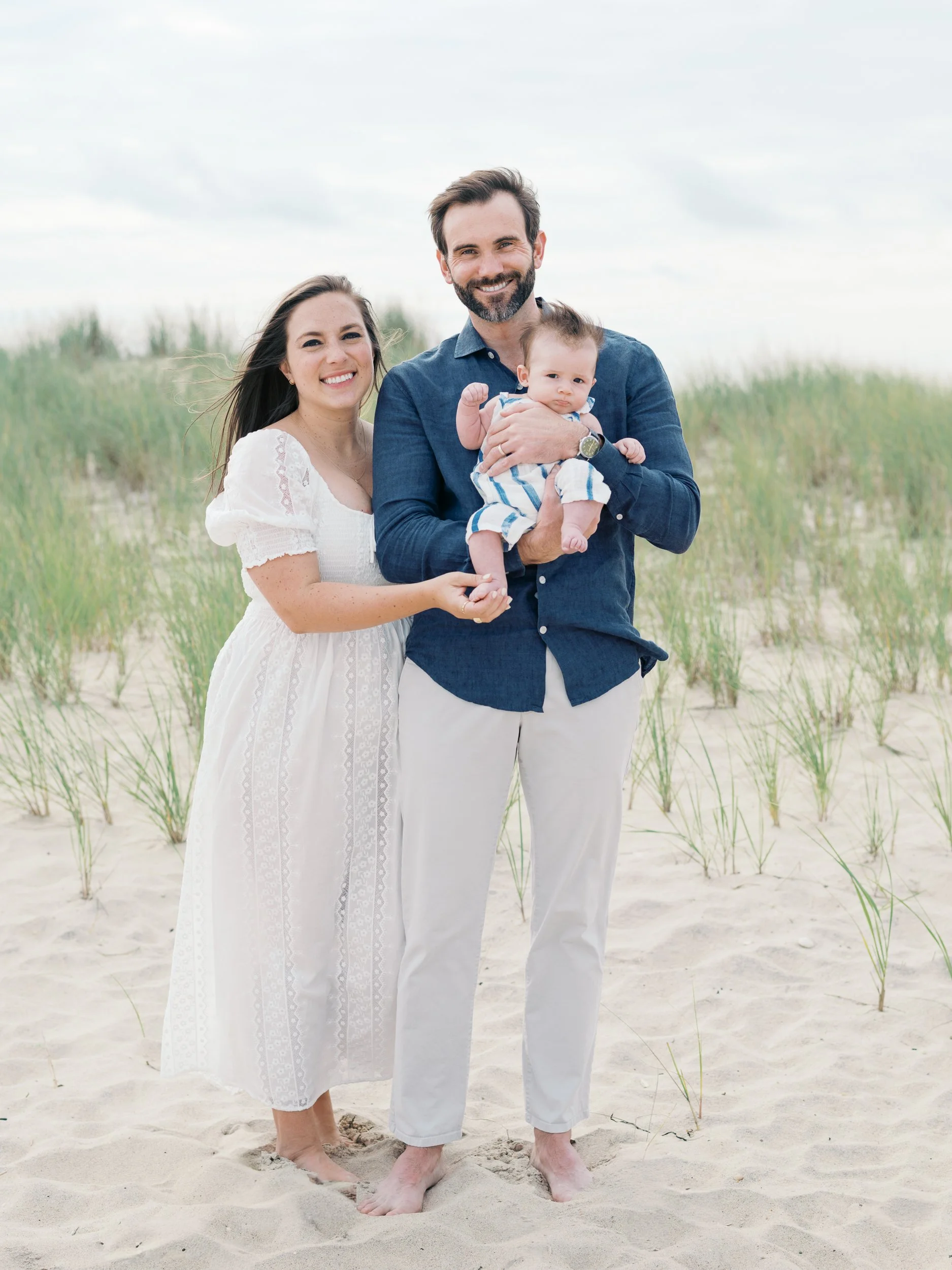 Mom and Dad holding baby boy on the beach in Bridgehampton, NY