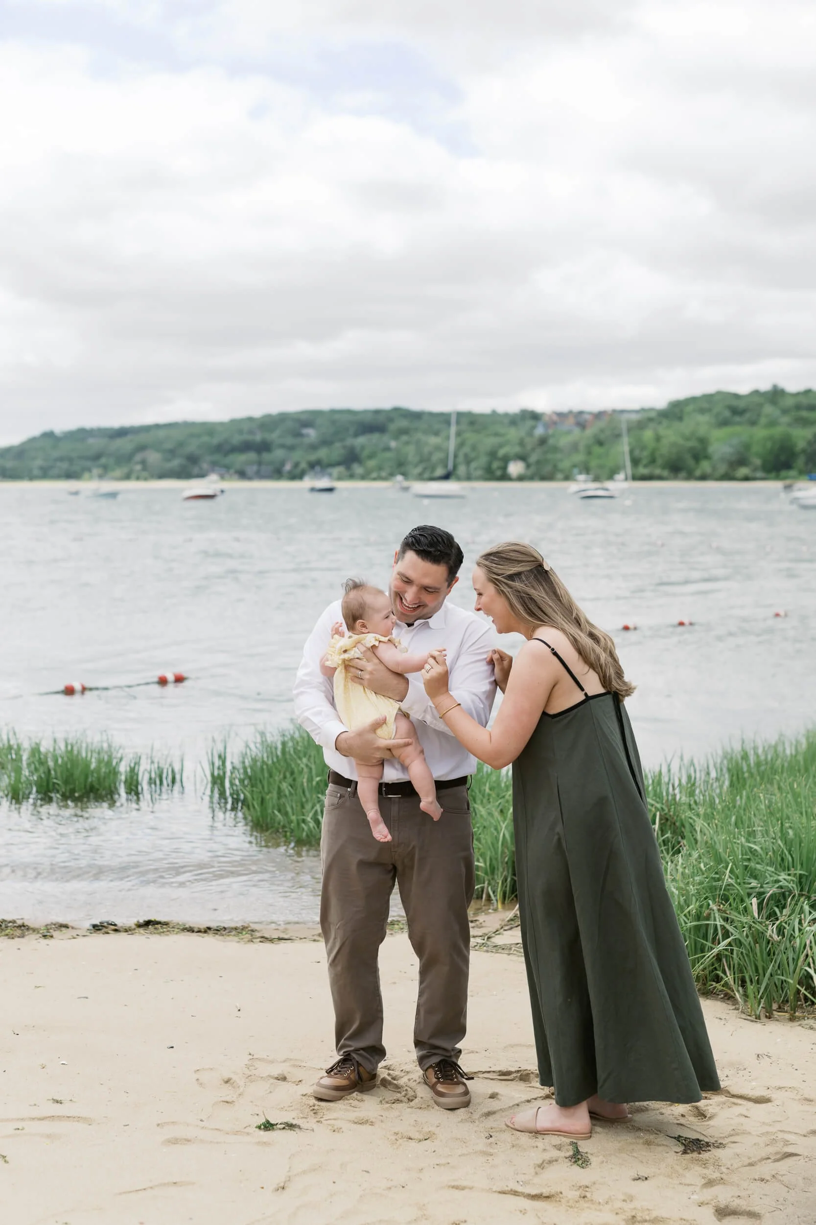 Mom and Dad Playing with Daughter on beach