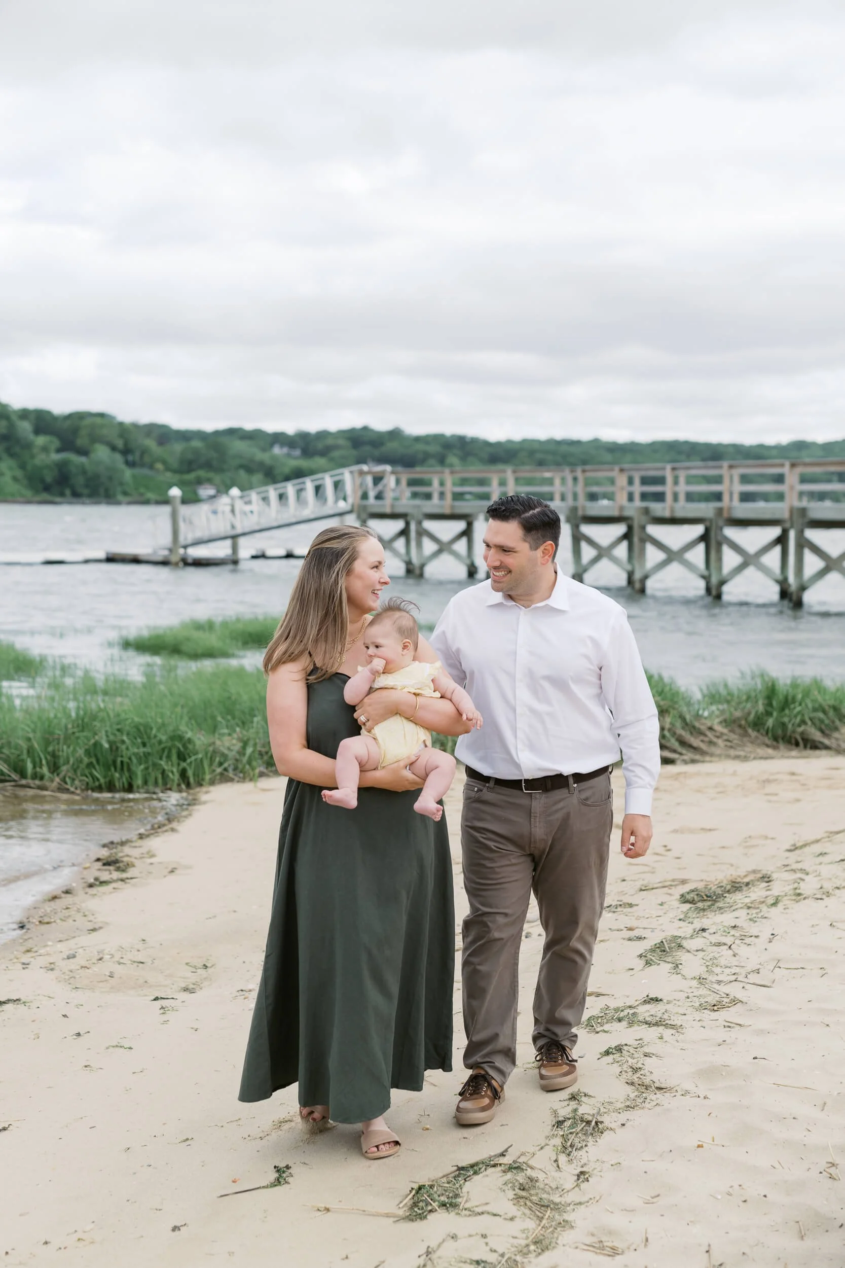Parents walking on the beach holding 6-month baby girl, New York Family photography