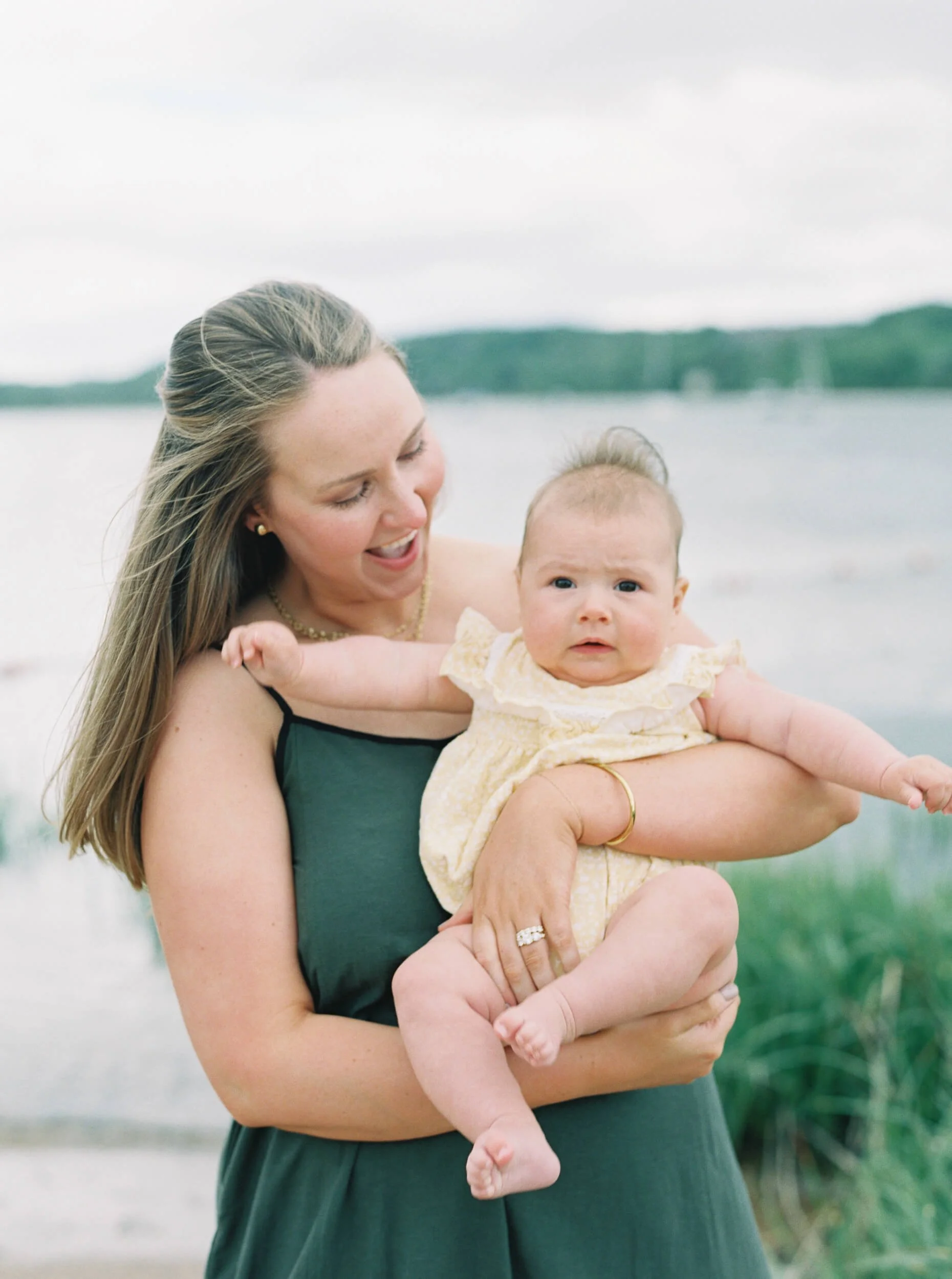 Mom holding Six Month old baby girl on the beach