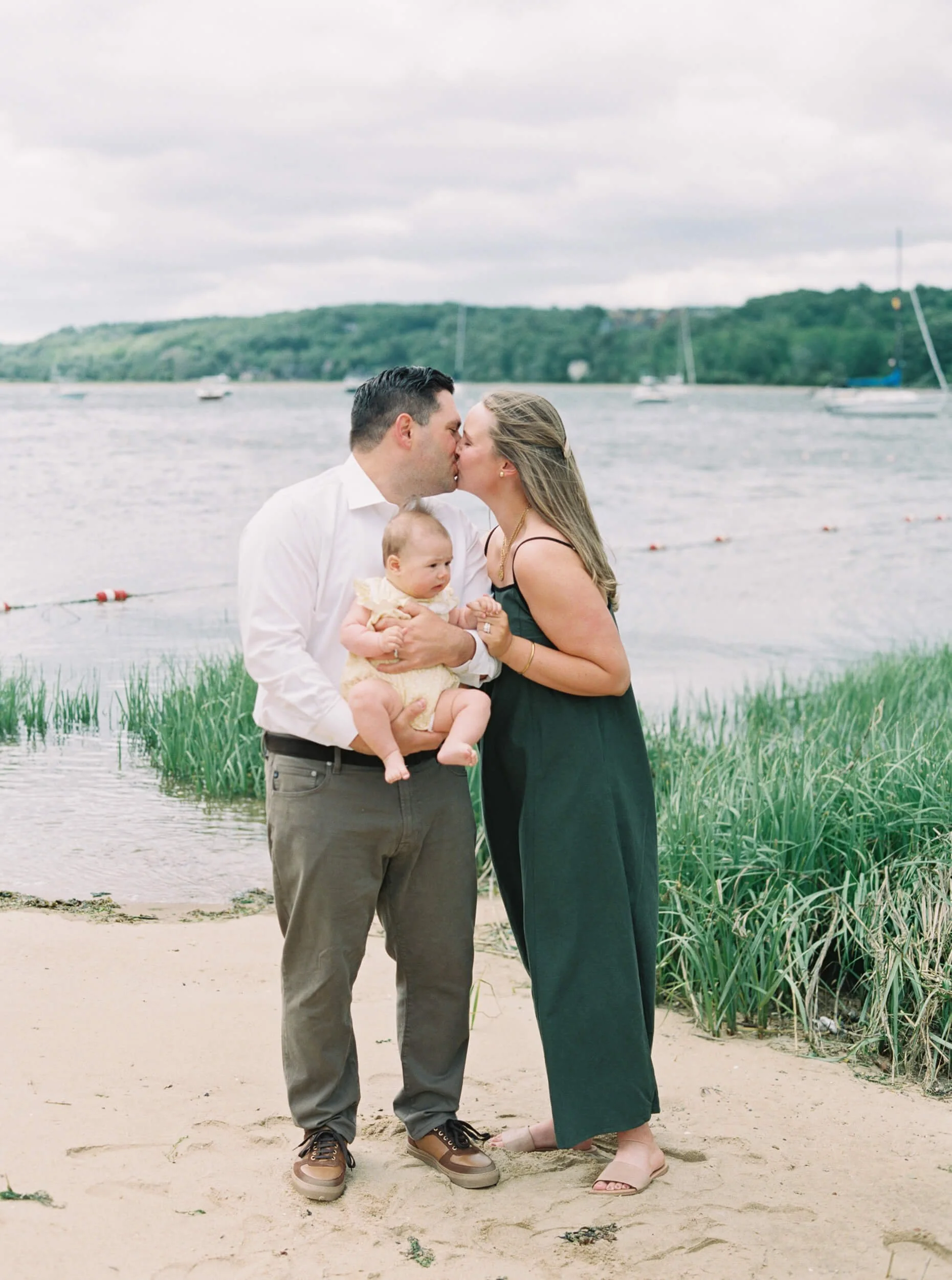 New Parents sharing a kiss on the beach for milestone session