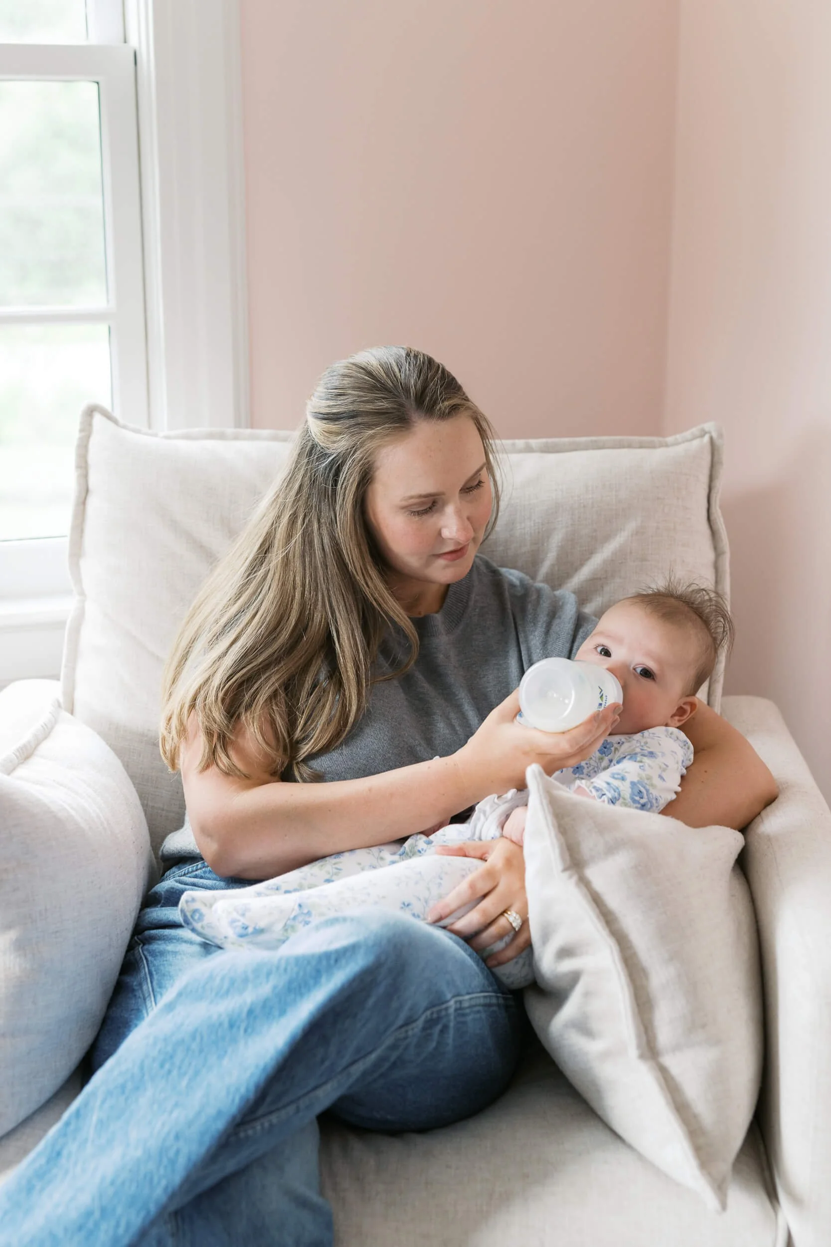 A tender family moment in the nursery, part of a six month milestone session with a Long Island family photographer.