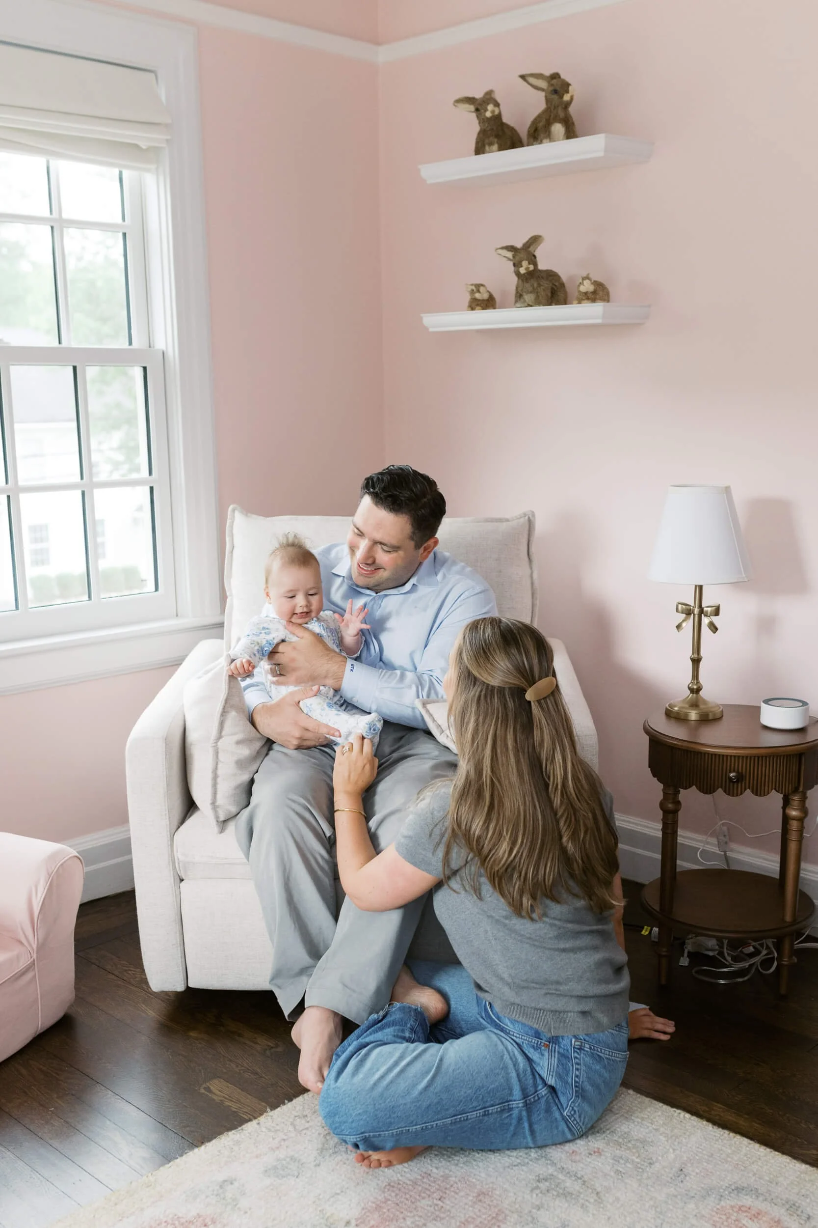 A tender family moment in the nursery, part of a six month milestone session with a Long Island family photographer.
