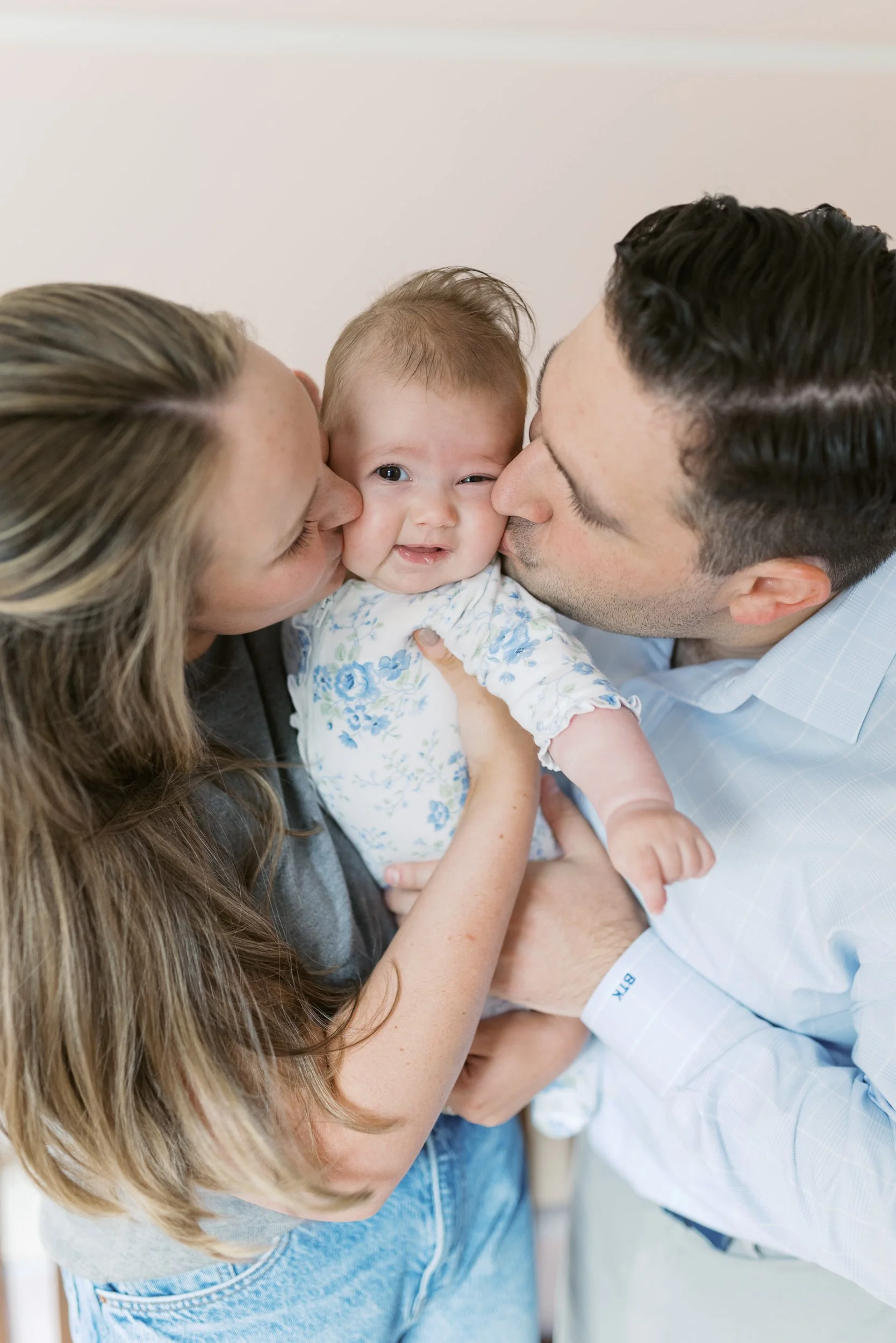 A six month old girl smiles at her parents inside her bunny themed nursery in Cold Spring Harbor.