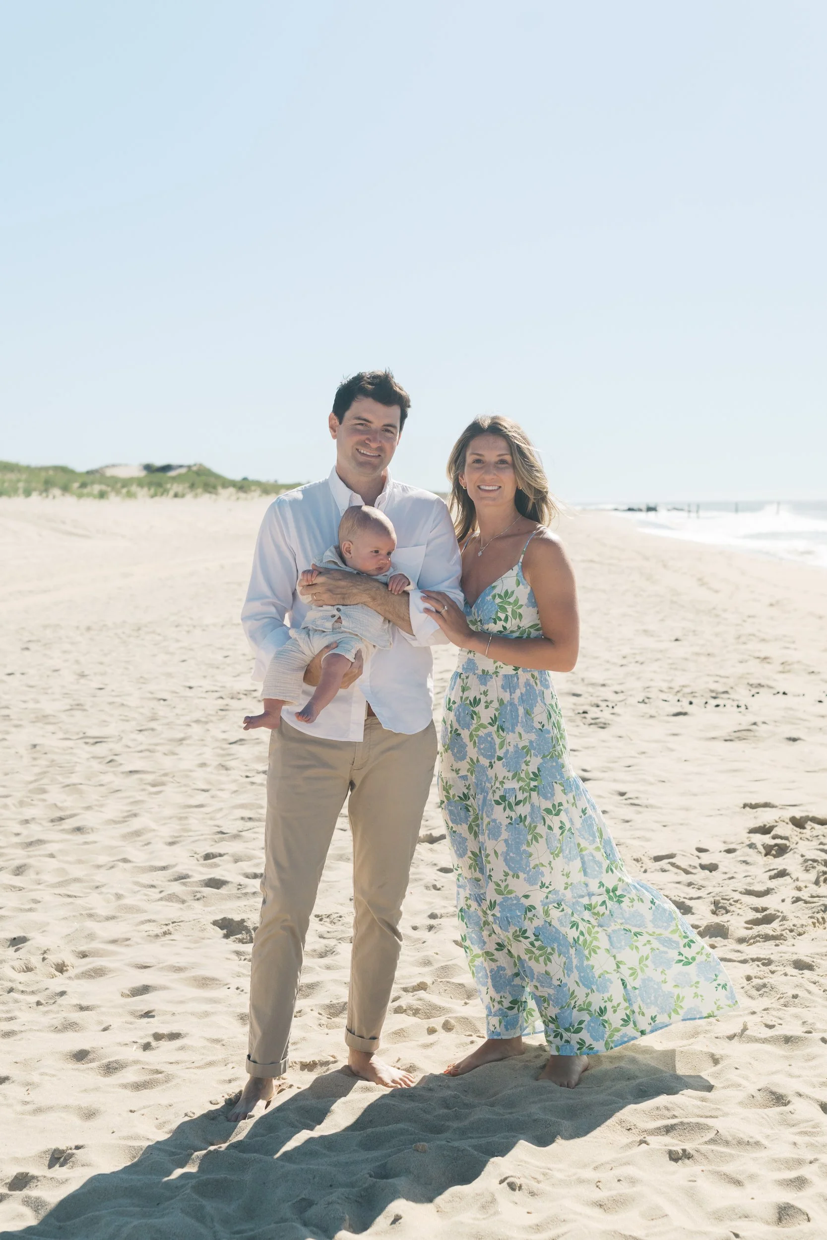 2. Family of three on the beach under a clear blue sky in East Hampton