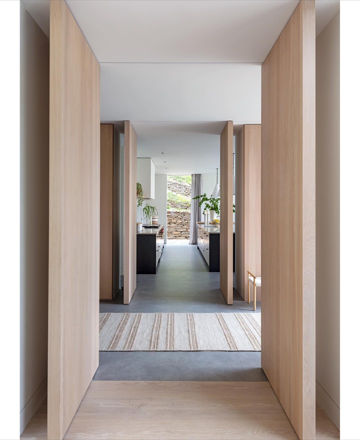 For this new beachside home in Cornwall we wanted to give the family the flexibility of having open plan spaces which could become more private when required. The  bespoke timber pivot doors do this beautifully. When closed they form the timber walls