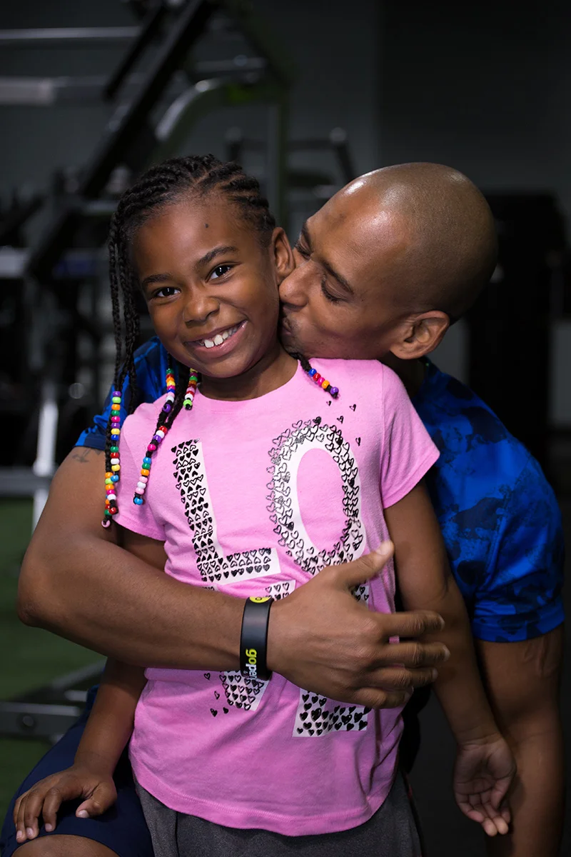 Coach-Louis-Allen-with-daughter.jpg