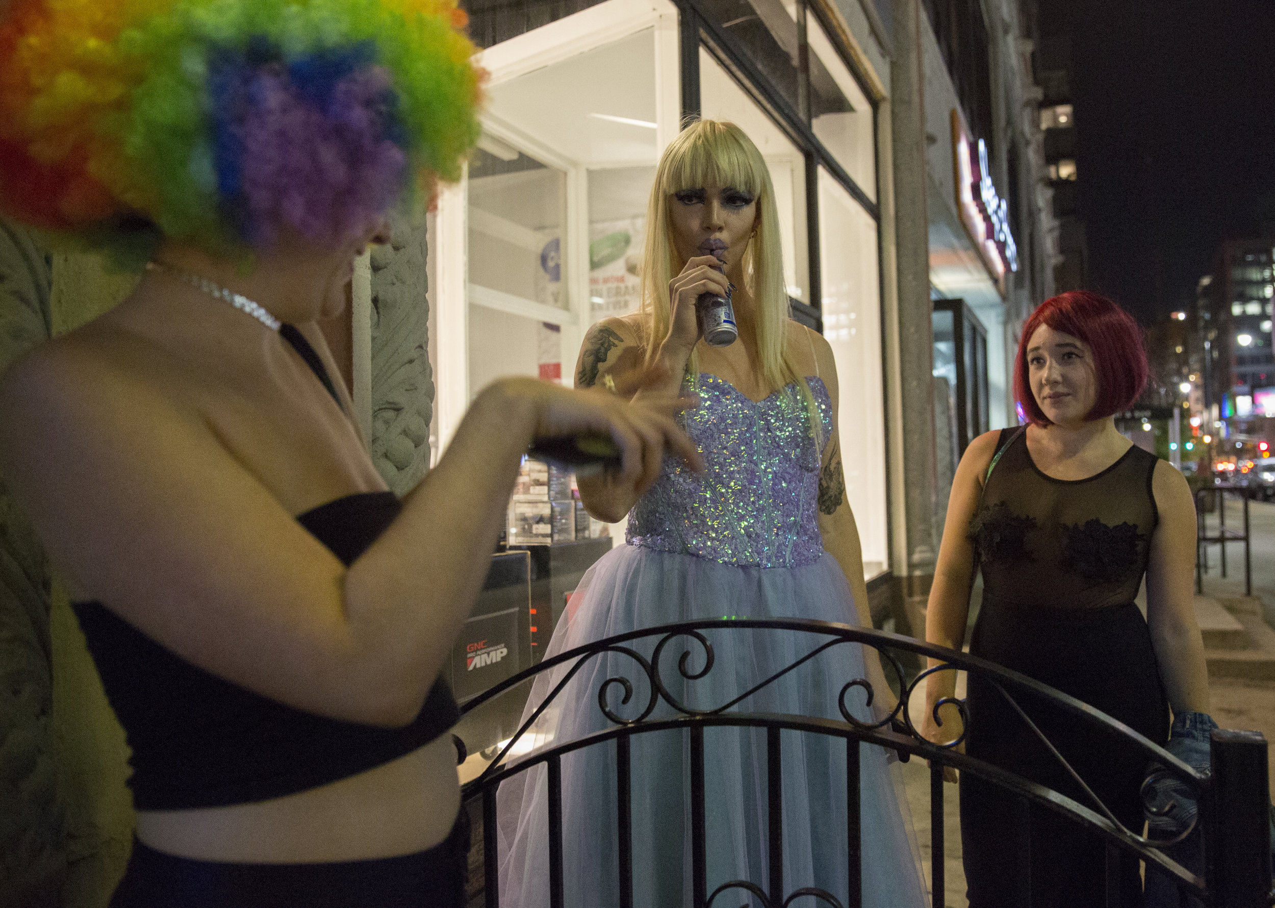 Rather than socialize with the other drag queens in the club’s dressing room, Ophelia opts for a moment outside with friends Tori Baisden, 22, left, and Hannah Lifshutz, 23. She opts to sip on a Red Bull rather than an alcoholic beverage after a recent decision to live a sober lifestyle.