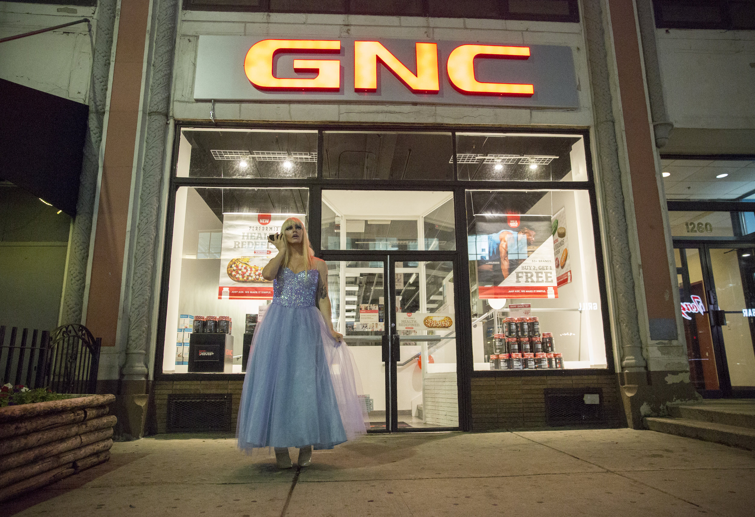Ophelia takes a moment for herself outside the club to listen to the song she plans to perform later that evening.