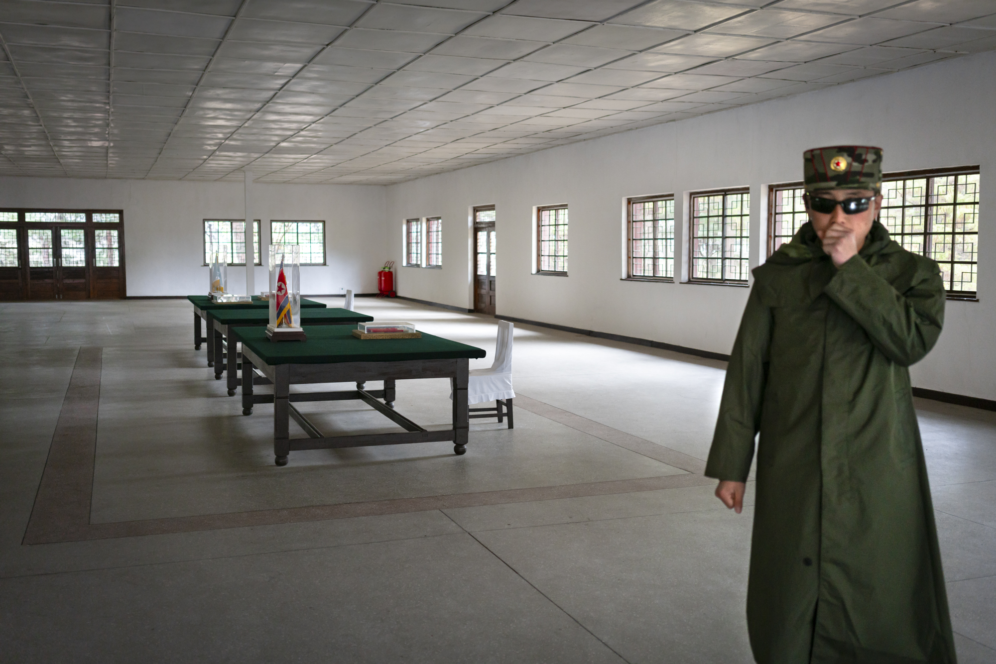 A North Korean soldier in the Armistice room, wherein 1953 North and South signed a truce that stopped hostilities, thus ending the Korean war and establishing the current borders.