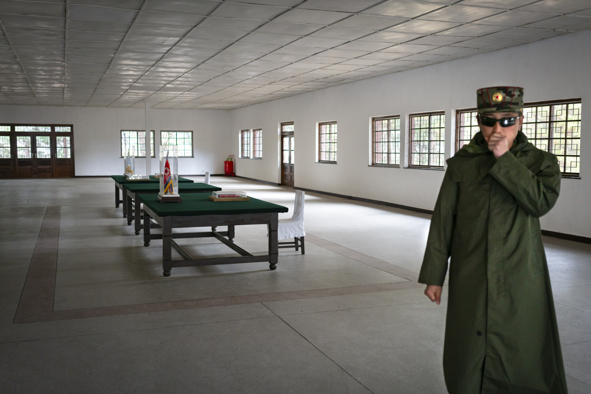  A North Korean soldier in the Armistice room, wherein 1953 North and South signed a truce that stopped hostilities, thus ending the Korean war and establishing the current borders. 