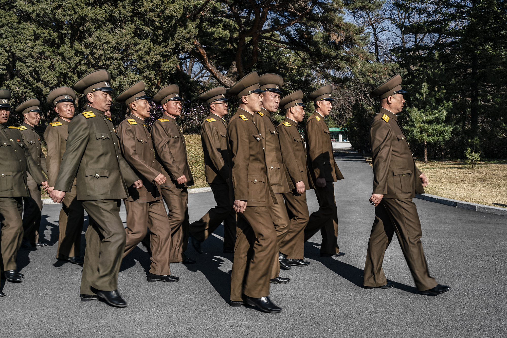  North Korean army officials marching in Mangyongdae, Pyongyang.  The area was designated as historic and listed as a revolutionary site by Kim Jong Il to solidify the North Korean cult of personality centred around him and his father, Kim Il Sung. 