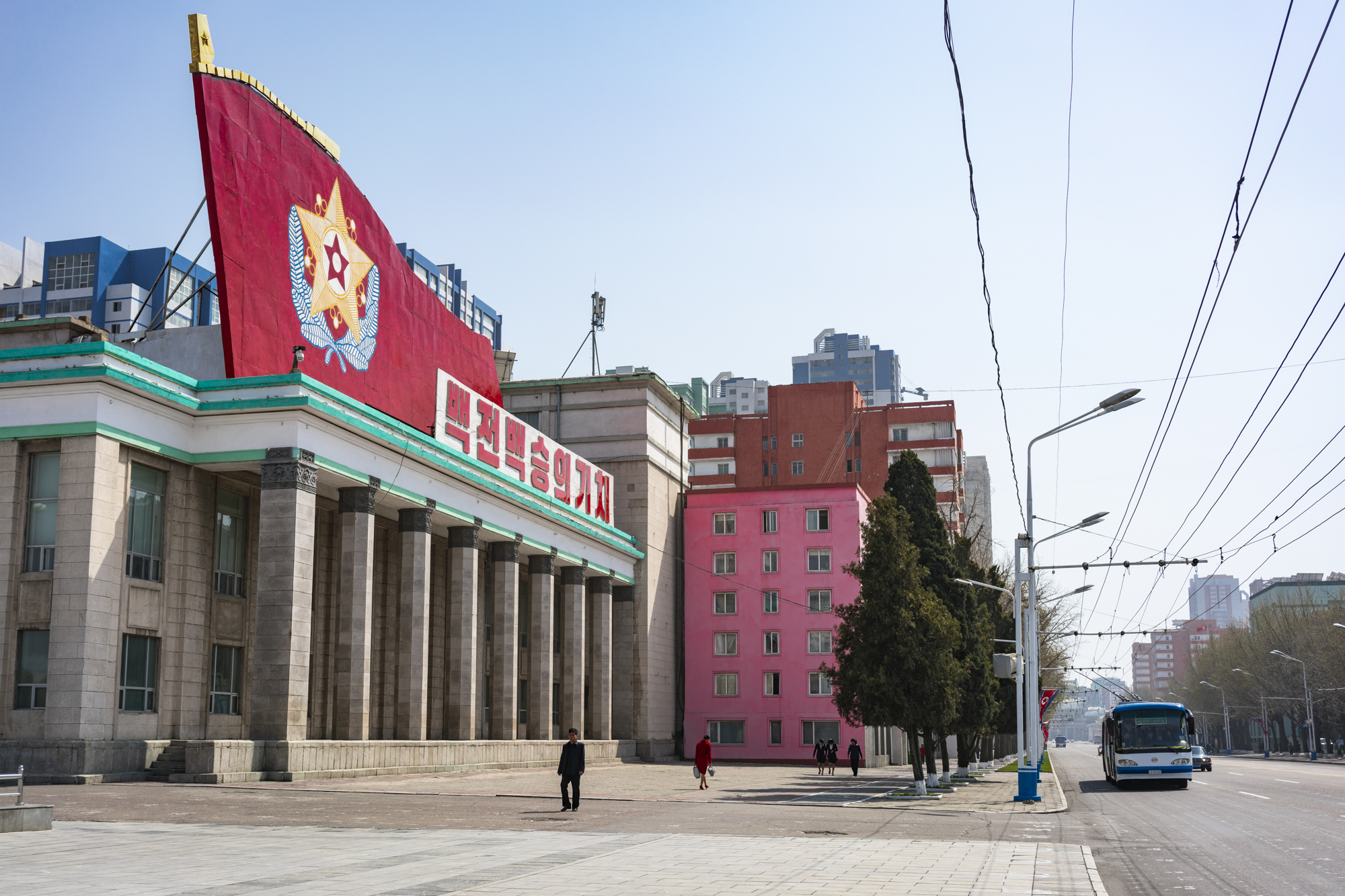 Building topped by revolutionary decoration, across from Kim Il Sung Square.