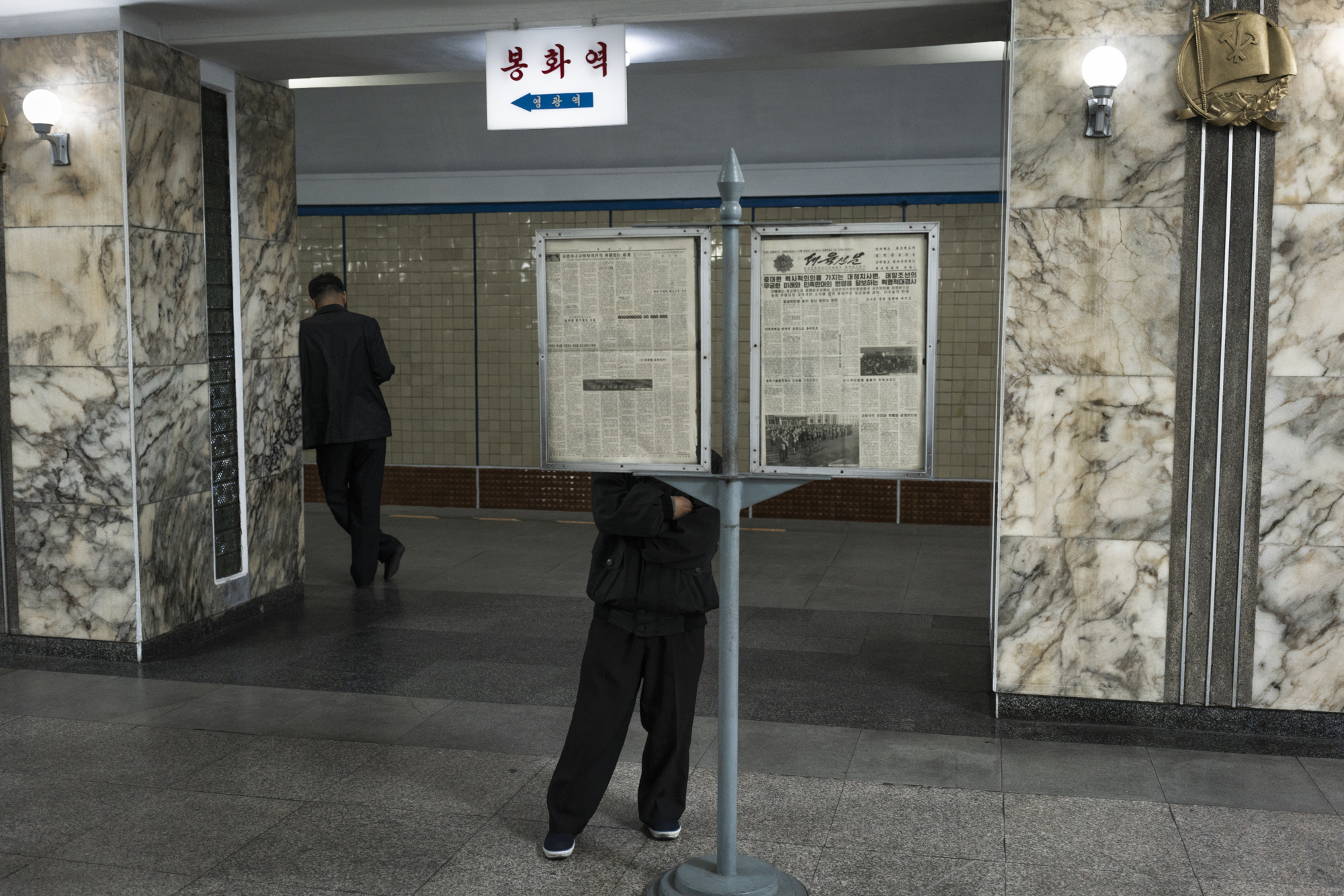  At the Pyongyang metro Station, on the Chollima Line, a commuter is reading a daily report of the official newspaper of North Korea’s ruling Workers’ Party while awaiting the train.  Newspapers in North Korea go through tight censorships by the PAD 