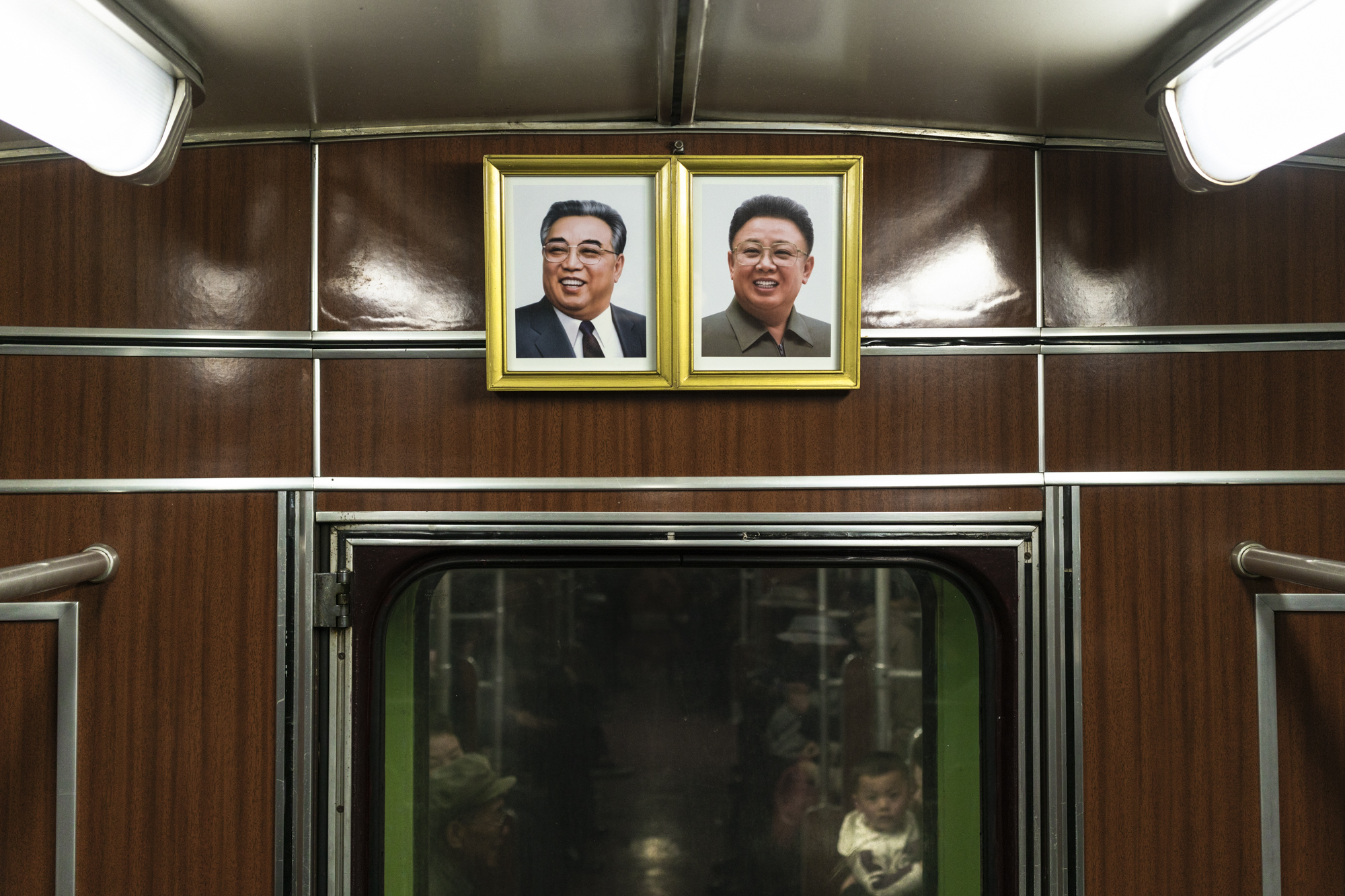 The centrality of the Leaders can be seen in everyday’s life. In the Pyongyang subway, portraits of Kim Il Sung and Kim Jong Il are present in every train carriage. By law, the structures of the frames are made thicker on the top side and angled do