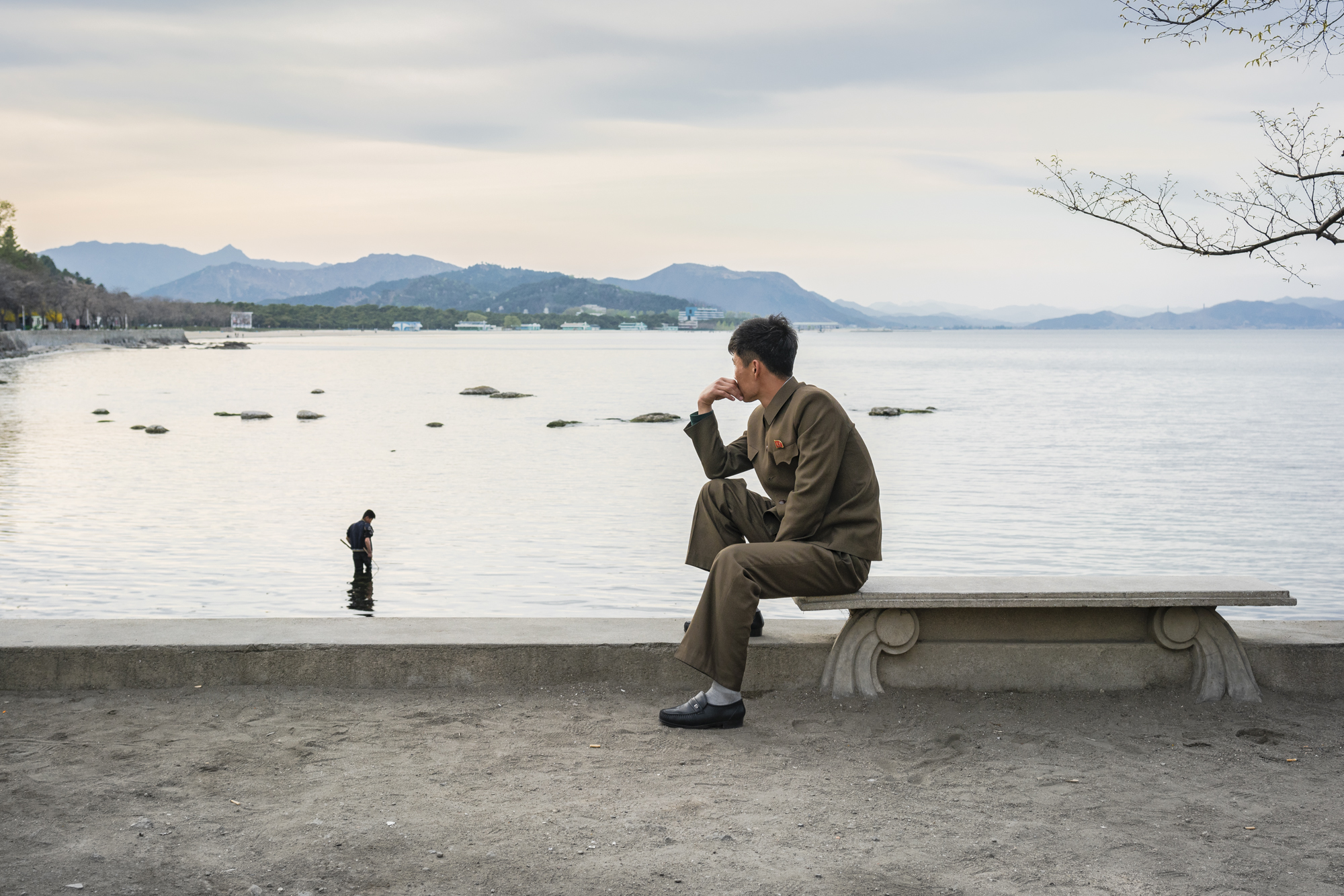  As the sun sets behind the hills on eastern side of the Korean Peninsula, North Koreans enjoy the warm temperatures on the shoreline in Wŏnsan. 