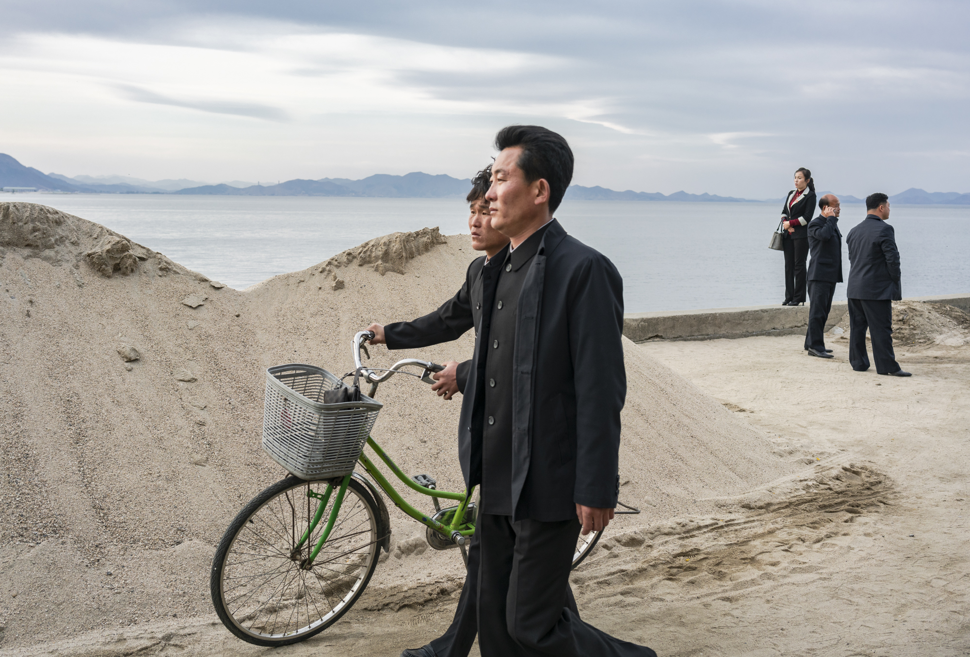  North Koreans returning from the pier that connects the Wŏnsan docks to Jangdok Islet.  To visit the small island and the Changdokdo lighthouse, foreigners are asked to pay a $1 entry fee. The pier itself is considered an attraction amongst locals w