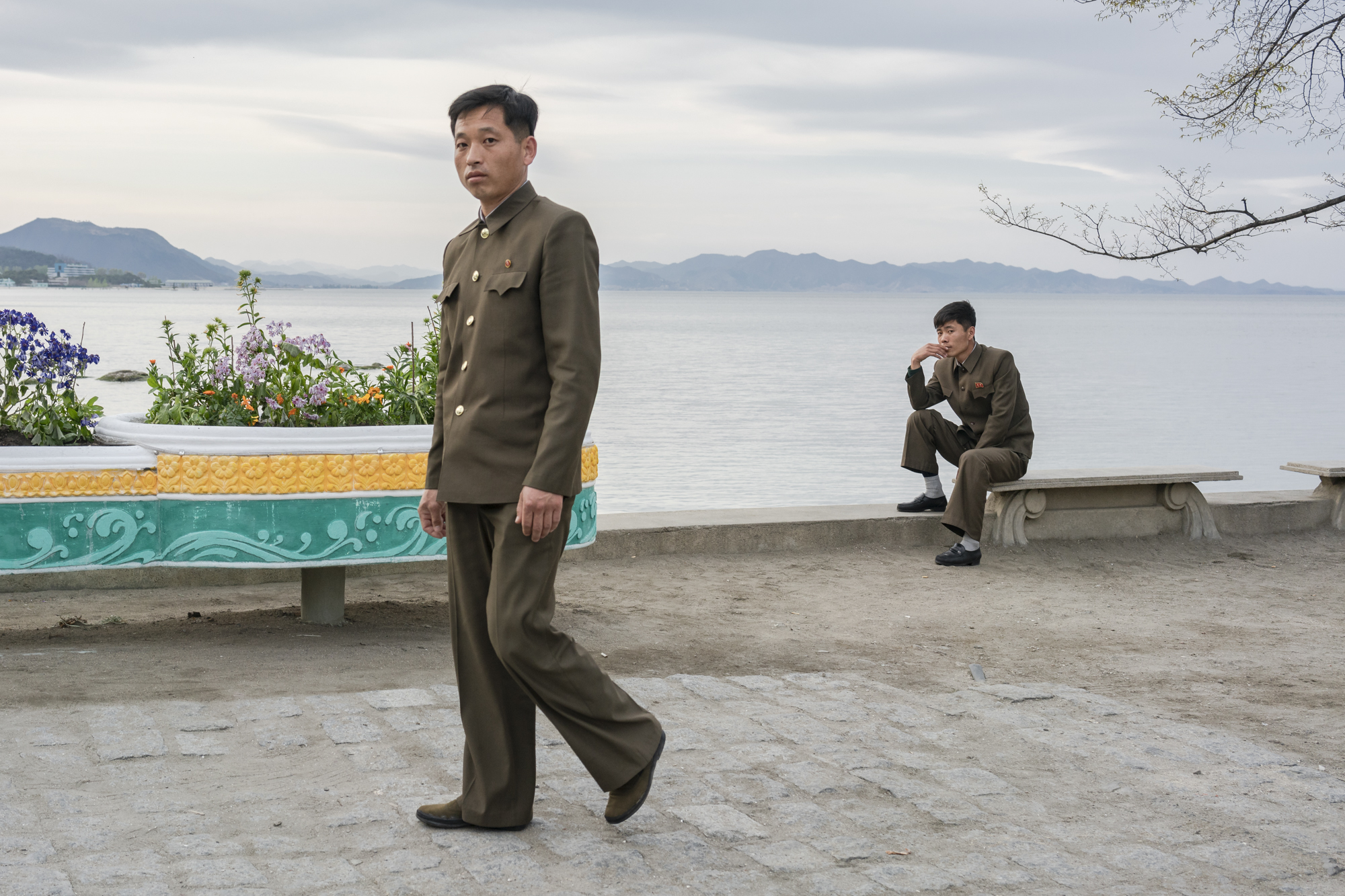 Uniformed North Koreans on the seaside in Wŏnsan, a port city and naval base located in Kangwŏn Province, along the eastern side of the Korean Peninsula.