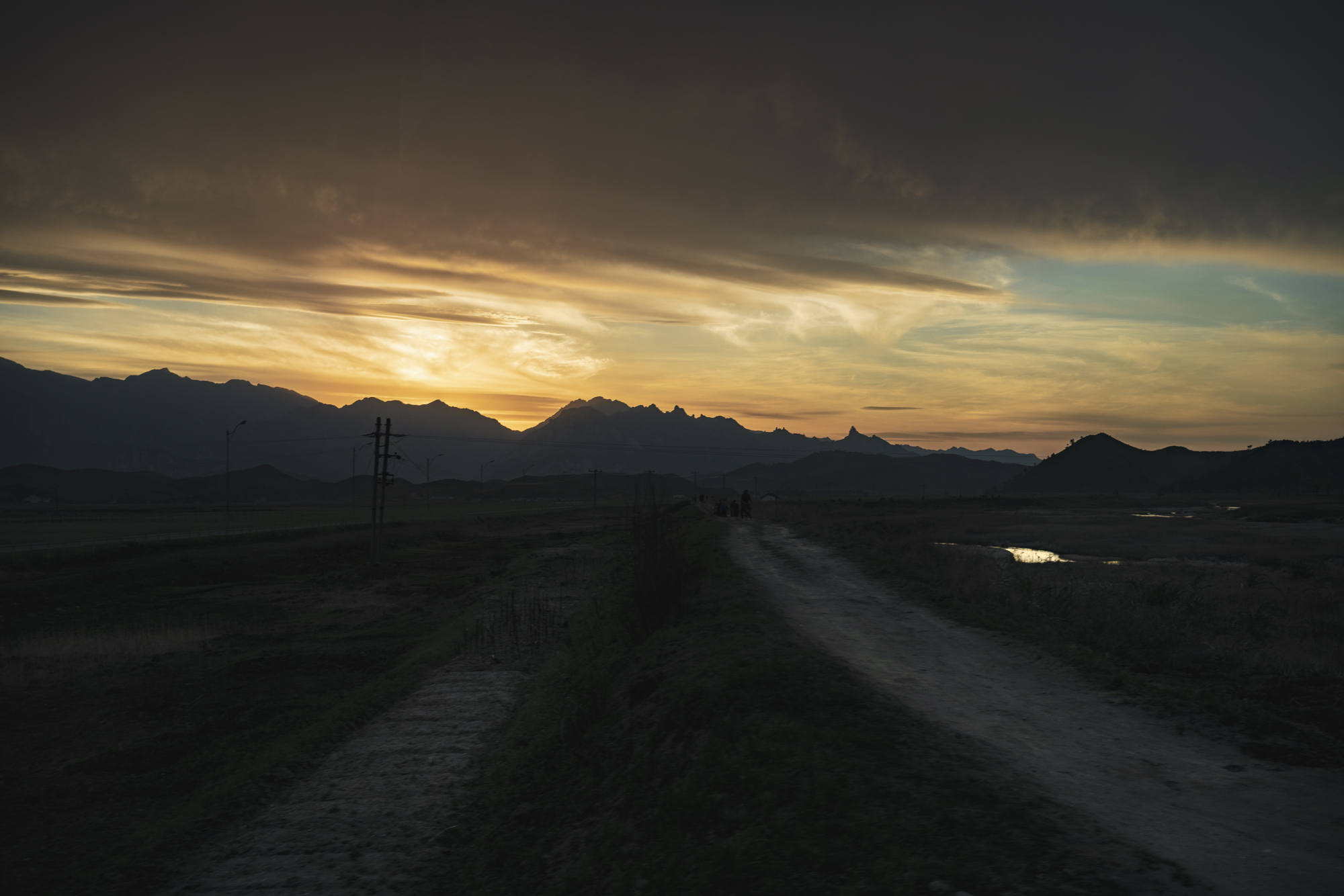  Sunset above the Mt. Kumgang National Park, in the south-east of North Korea.  For its geographical conditions with many hills and plateaus, the farming activities around the Mt. Kumgang Biosphere Reserve are mainly focused on the cultivation of non