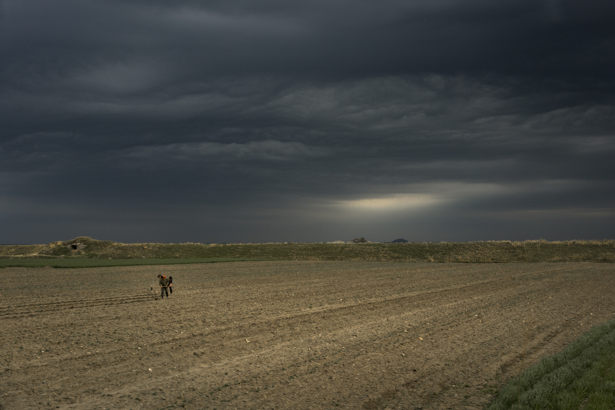  Farmers working the land in the Kangwŏn Province on the North Korean South-East coast near the Sea of Japan, also known as the “East Sea”.  Farming in North Korea is concentrated in the flatlands of the four west coast provinces where more favourabl