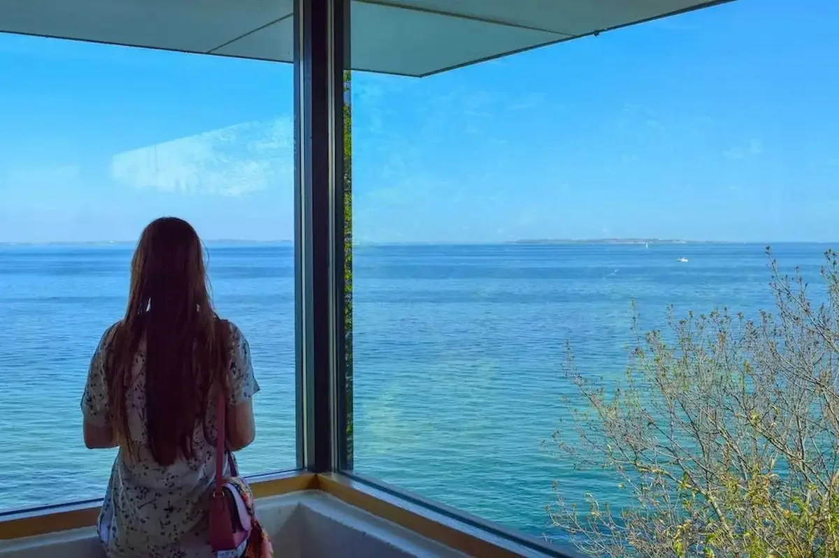 Amber looking outside the window at Louisiana Museum in Denmark