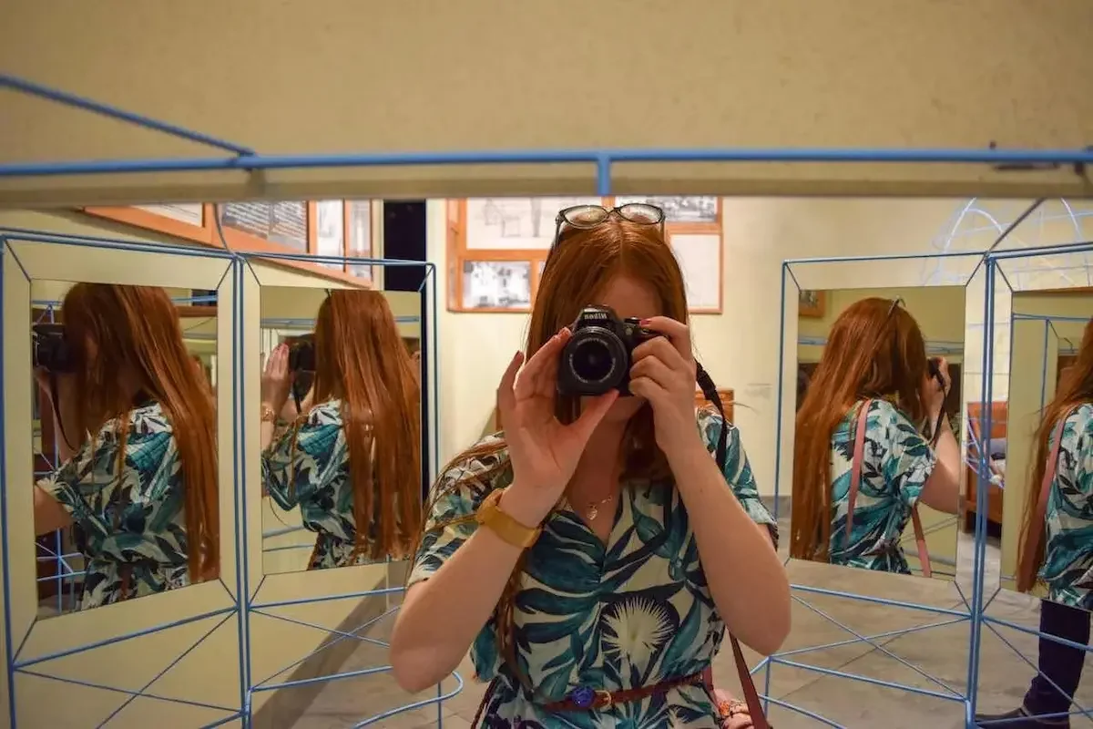 Amber at a mirrored chair installation at Design Museum Denmark, Copenhagen