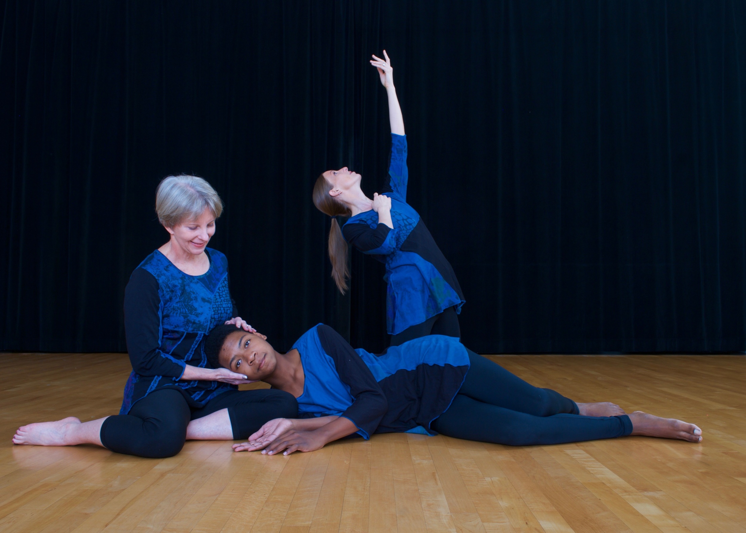 Dancers of all races and ages in a modern dance pose.