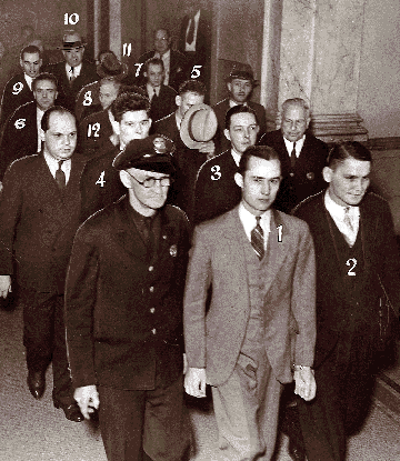 Twelve black legion members leave the courtroom after being found guilty of murder.
