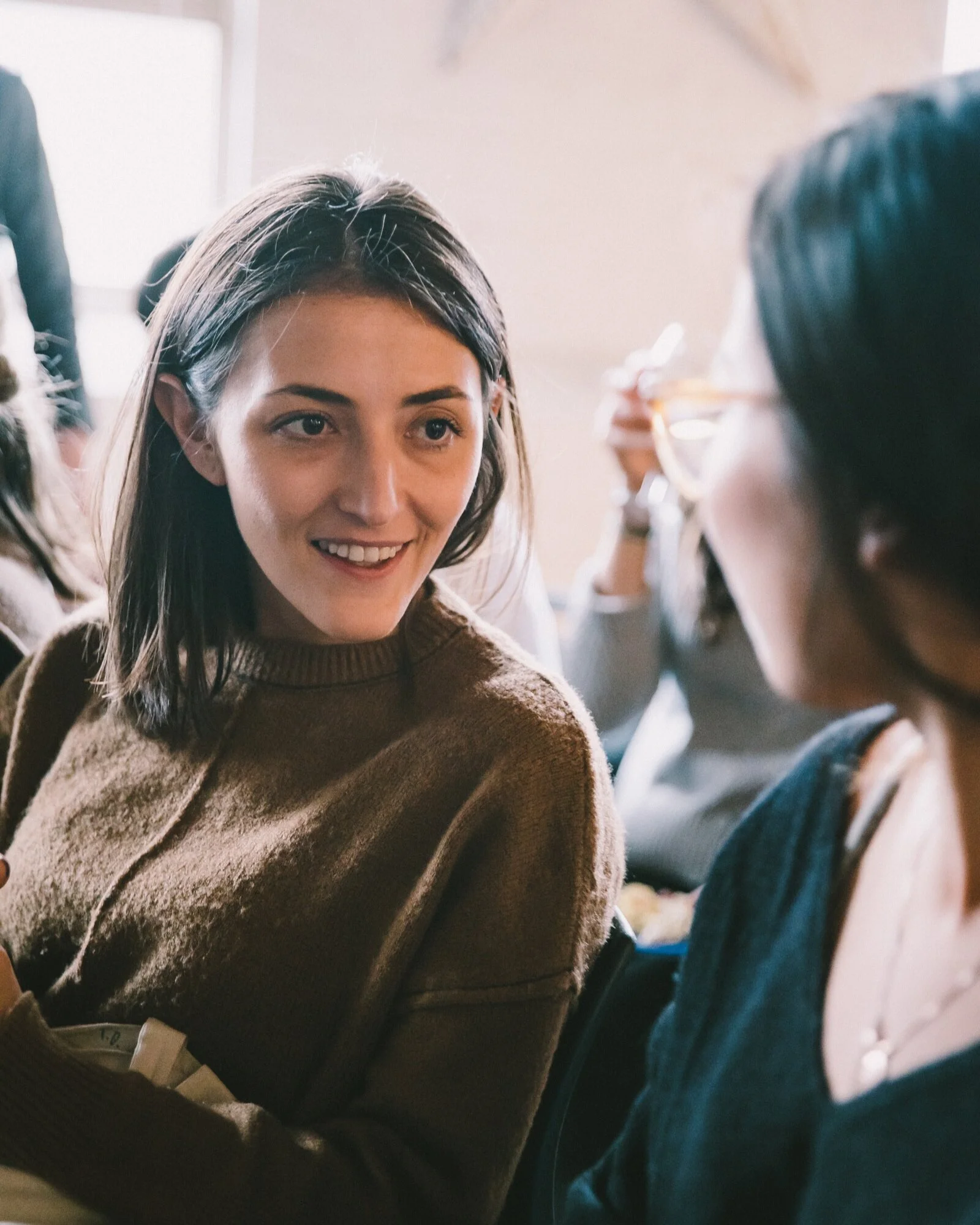 Woman+sitting+and+conversing+with+another+woman+at+a+Syzygy+women%27s+event.jpg