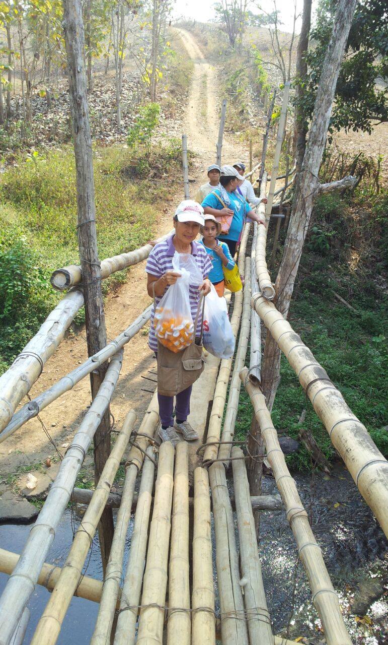  Church folk deliver vitamins to children 45 minutes down the trail. 