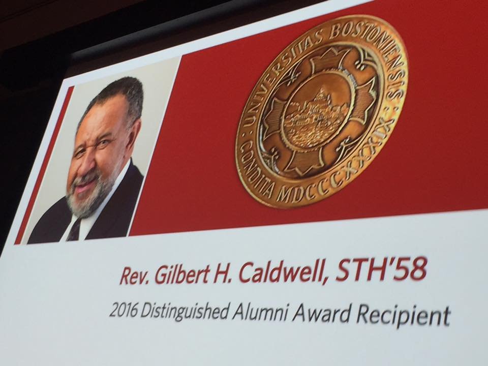 Image: A photo of a screen that shows a picture of the Reverend Gil Caldwell with text that reads "Reverend Gilbert H. Caldwell, STH'58 2016 Distinguished Alumni Award Recipient"