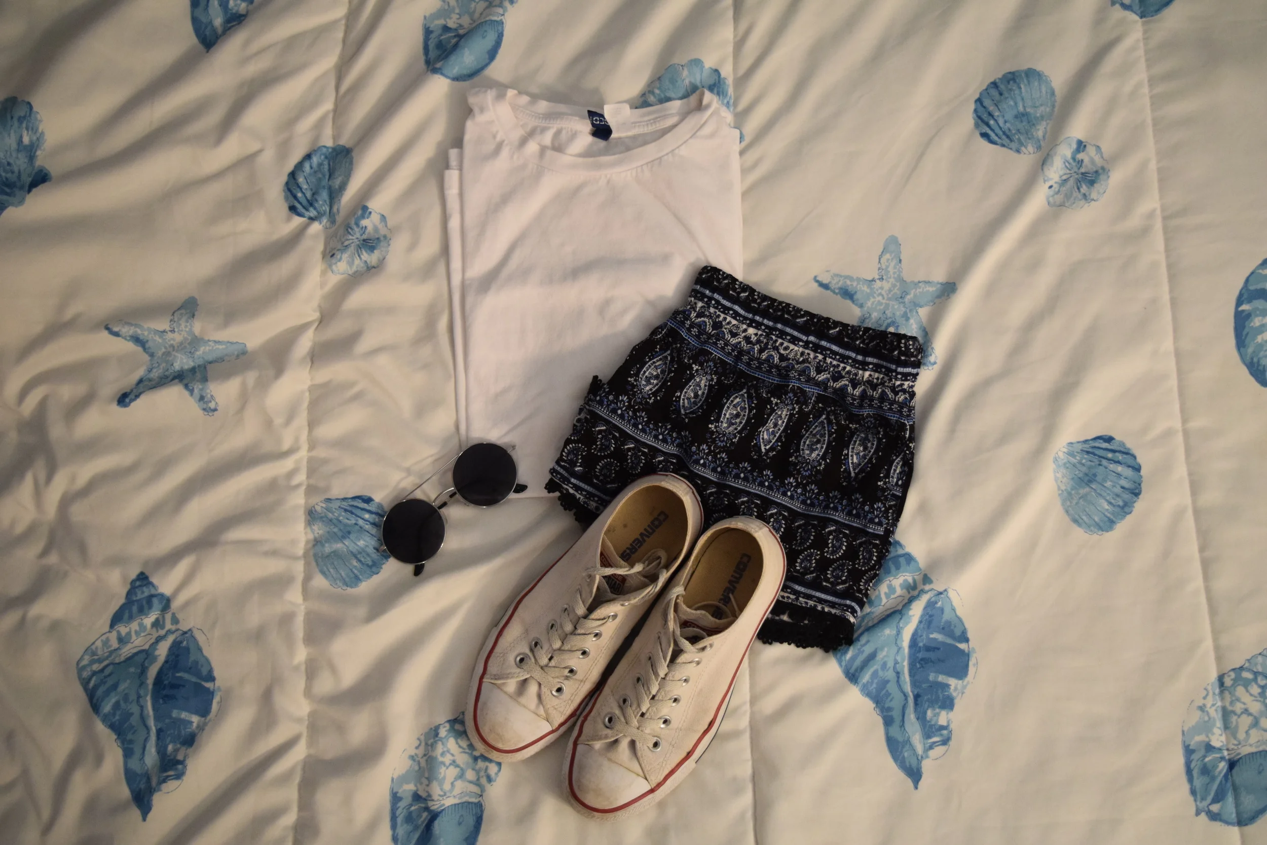 Shirt . Shorts . Sneakers . Sunglasses (similar).
