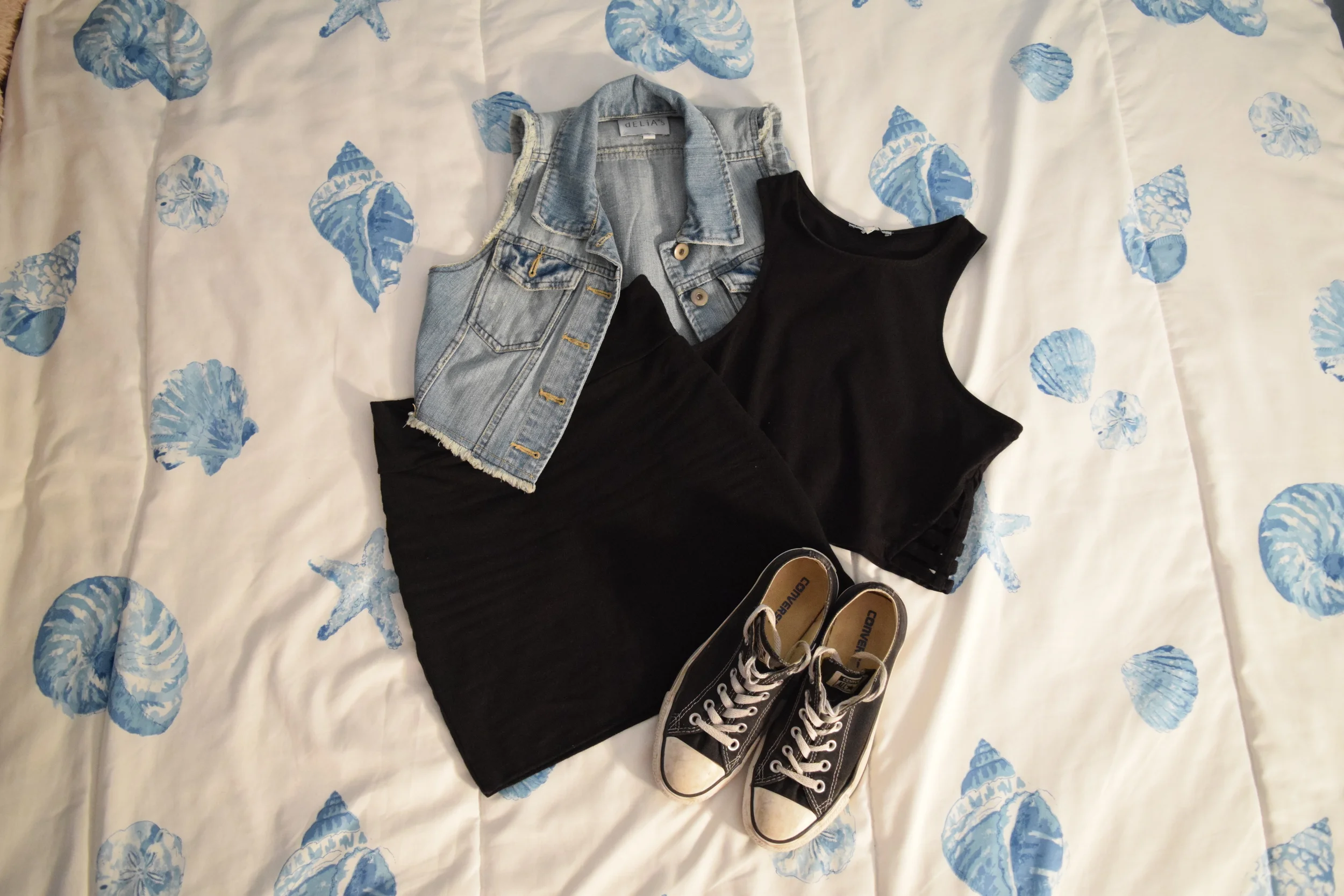 Denim Vest (similar). Crop Top (similar). Skirt (similar). Sneakers . 