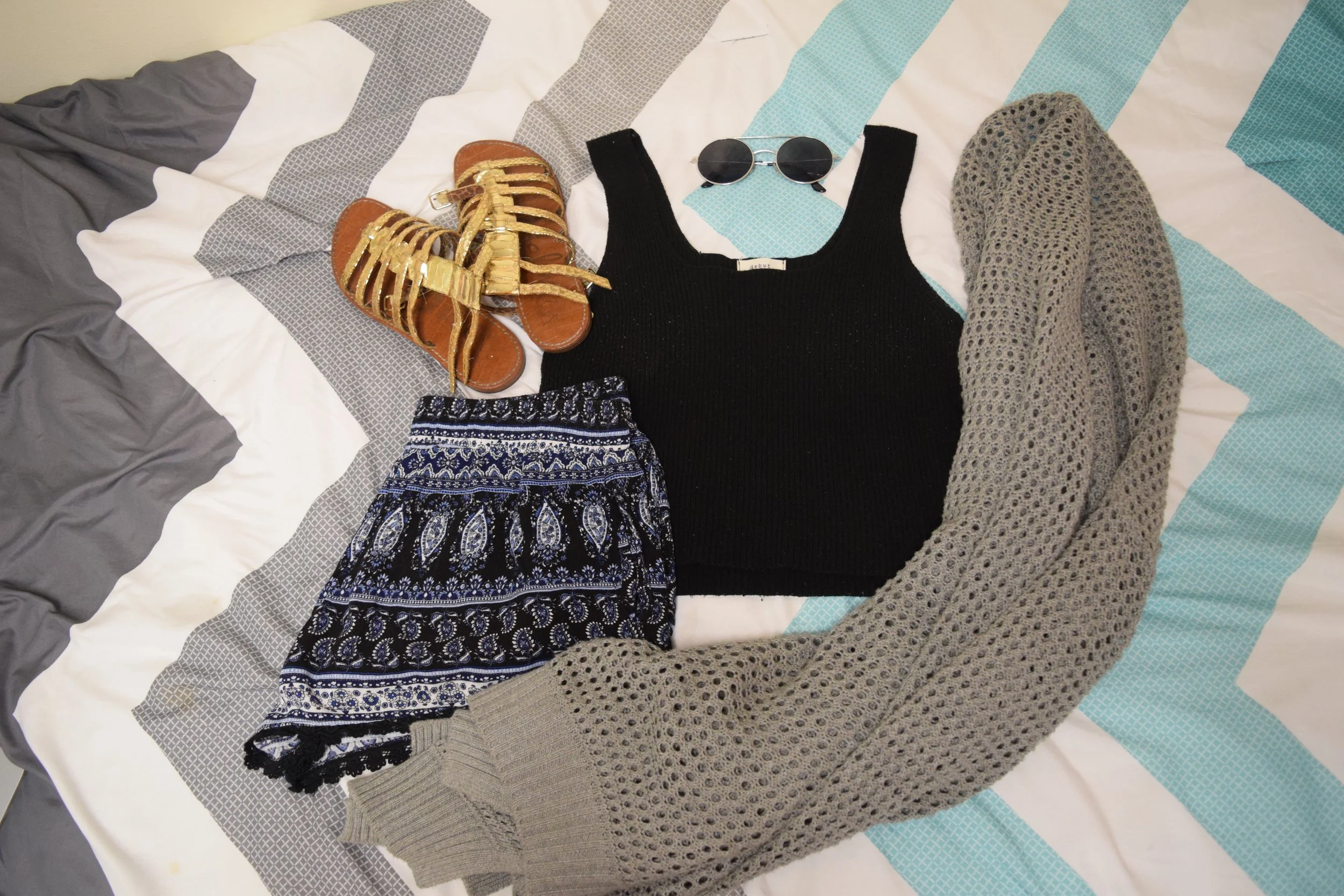 Top (no longer being sold at Urban Outfitters ). Shorts . Sandals (no longer being sold at Sam Edelman ). Sunglasses (similar). Sweater (no longer being sold at The Gap ). 
