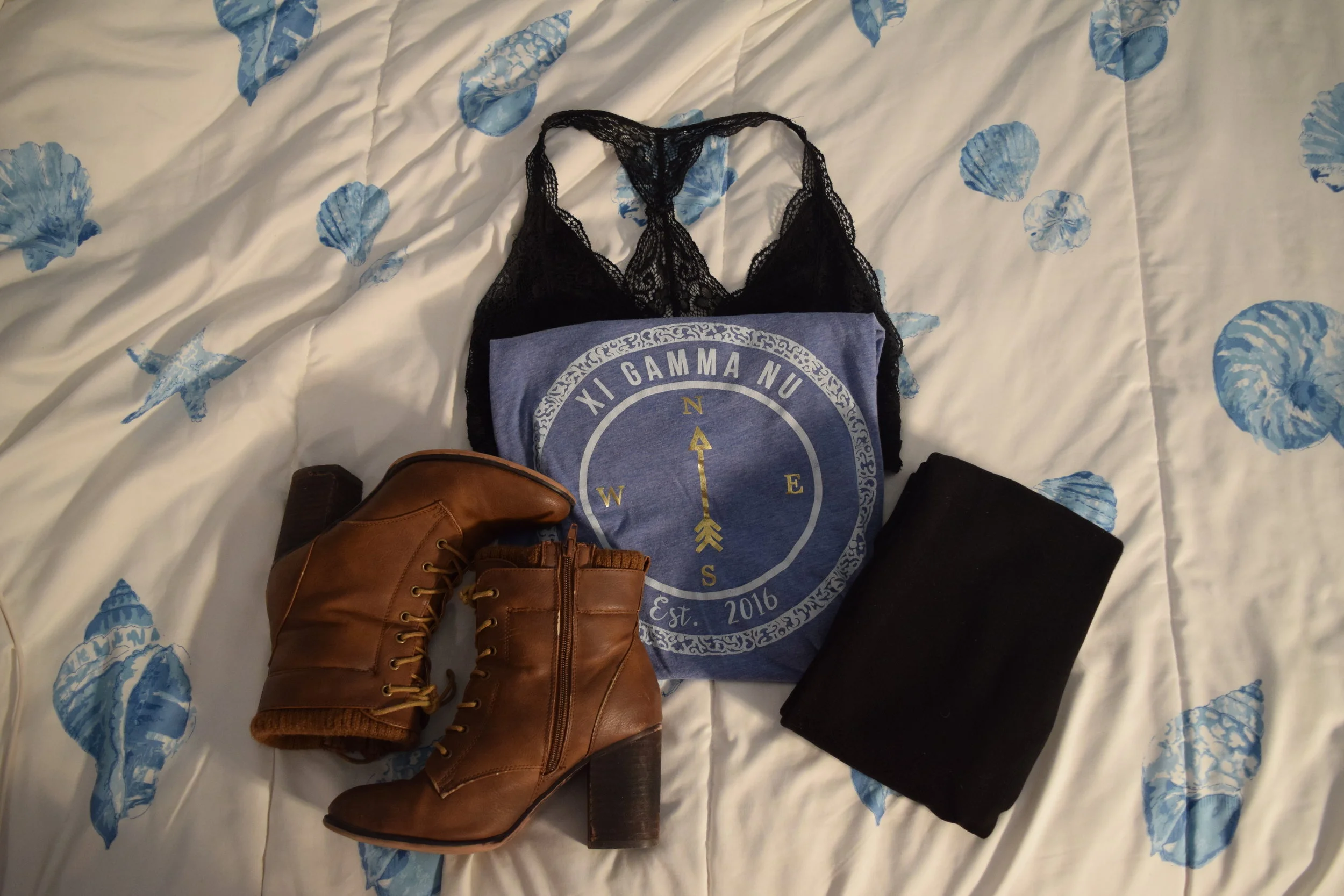 Shirt (exclusive to Xi Gamma Nu Emerson College). Leggings . Boots (no longer being sold by Call It Spring ). Bralette .