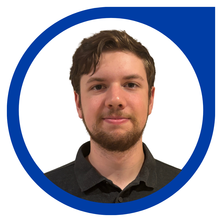 A young man with brown hair, a beard, and mustache, wearing a black collared shirt, smiling slightly, against a white background with a blue circular design.