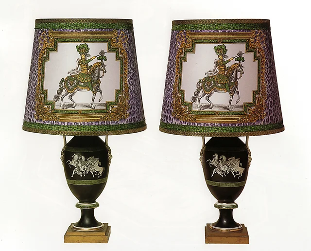 A Pair of Neoclassical Style Porcelain Vases mounted as Lamps, Late 19th Century; Gianni Versace designed silk lampshades in the 'Le Roi Soleil a Cheval' pattern combined with animal print backgroun