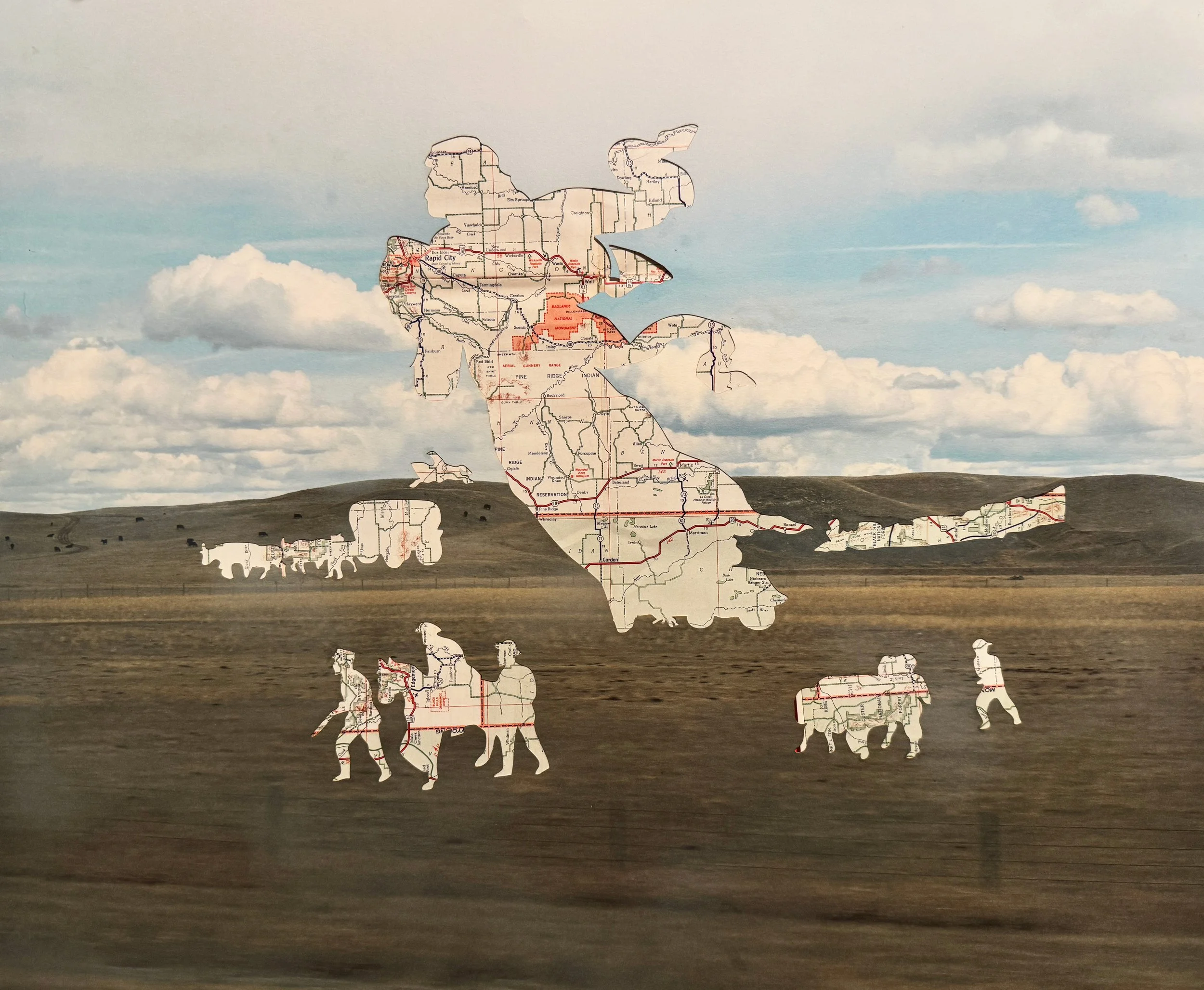 A cutout of a squirrel made from a map showing roads and locations, placed against a cloudy sky background.