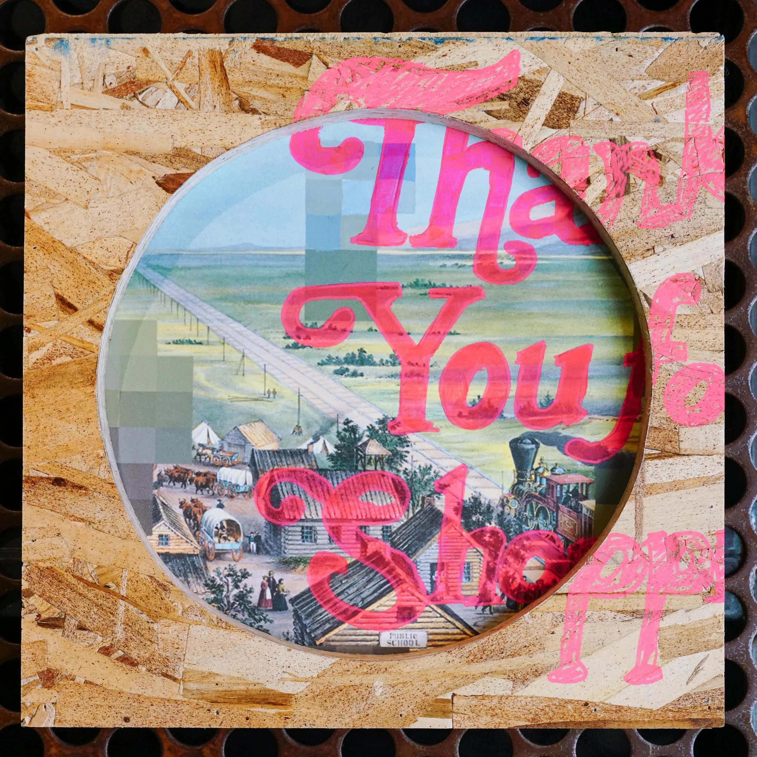 A close-up of a colorful illustration on a wooden surface, featuring a scenic landscape with a bridge and trees, with pink text and drawings overlaid and a label that reads 'Public School' at the bottom.