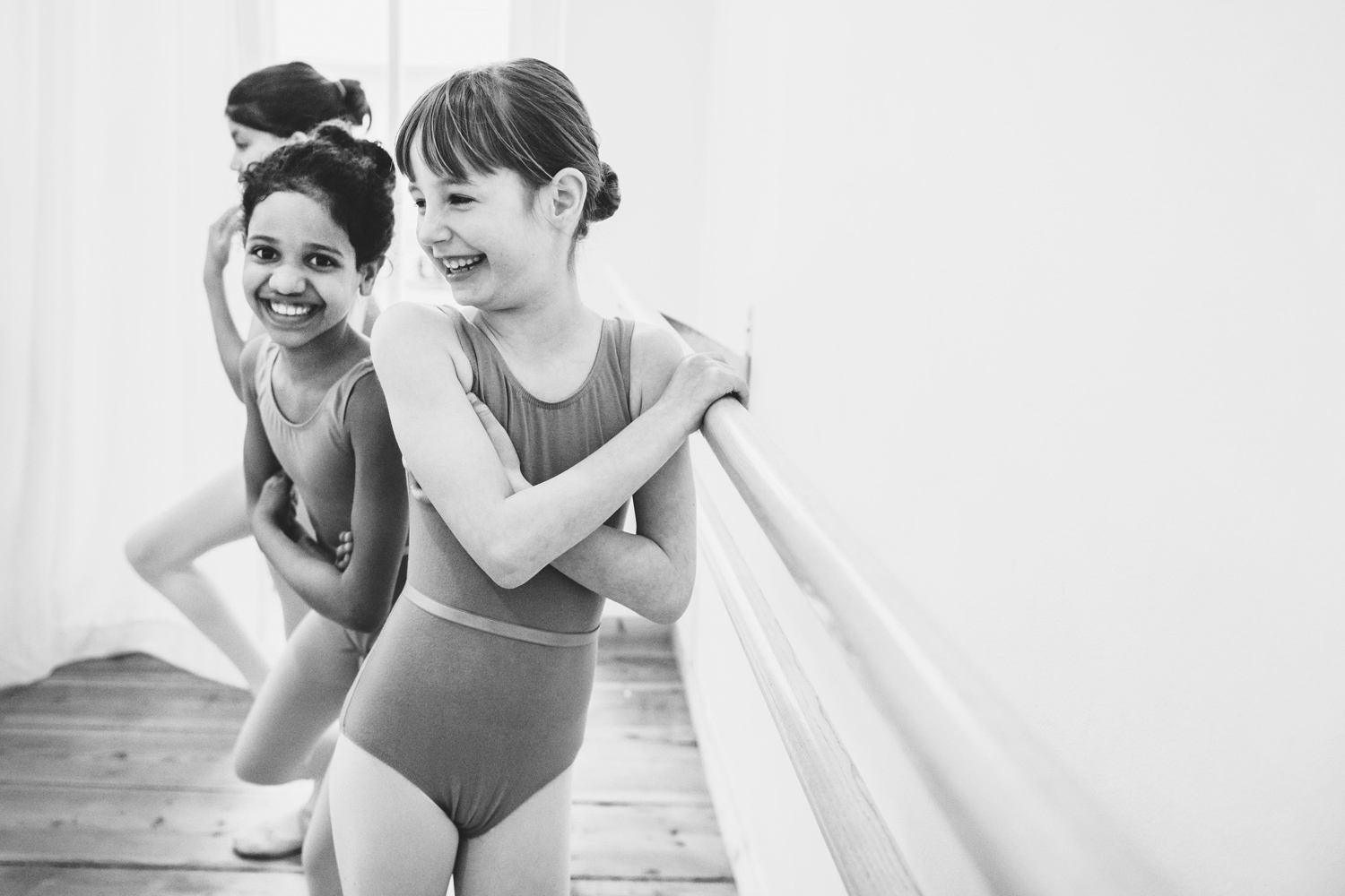 laughing girls in ballet leotards