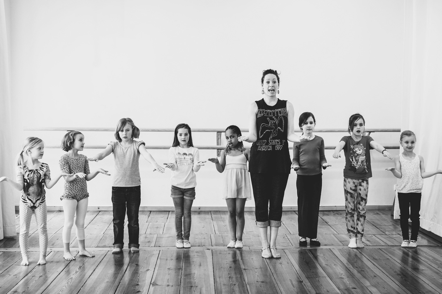 Young school children dancing - musical teacher